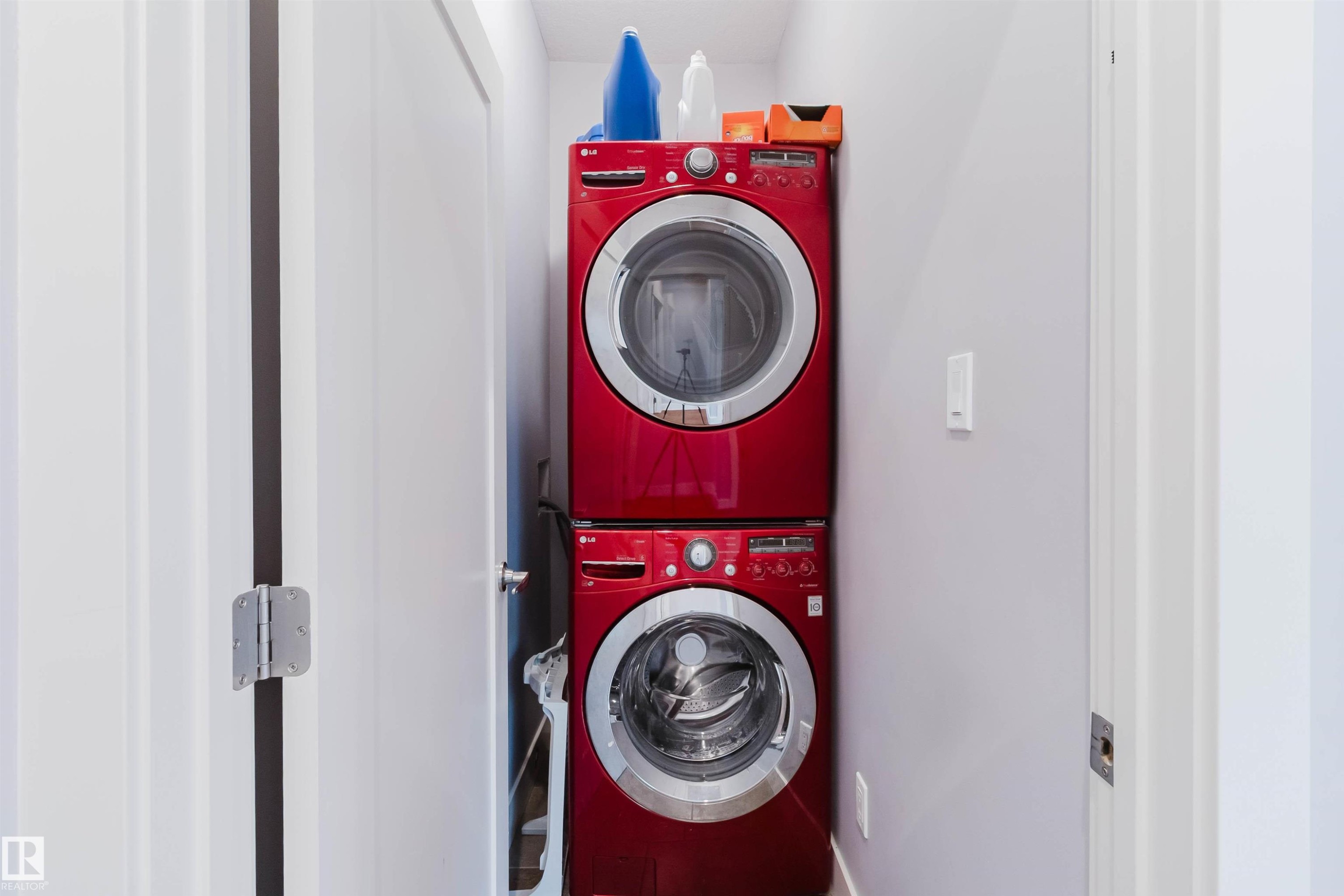 Dedicated laundry area featuring a stacked, front-loading washer and dryer set - 10626 81 Avenue Nw, Edmonton, AB - Indoor Photo Showing Laundry Room