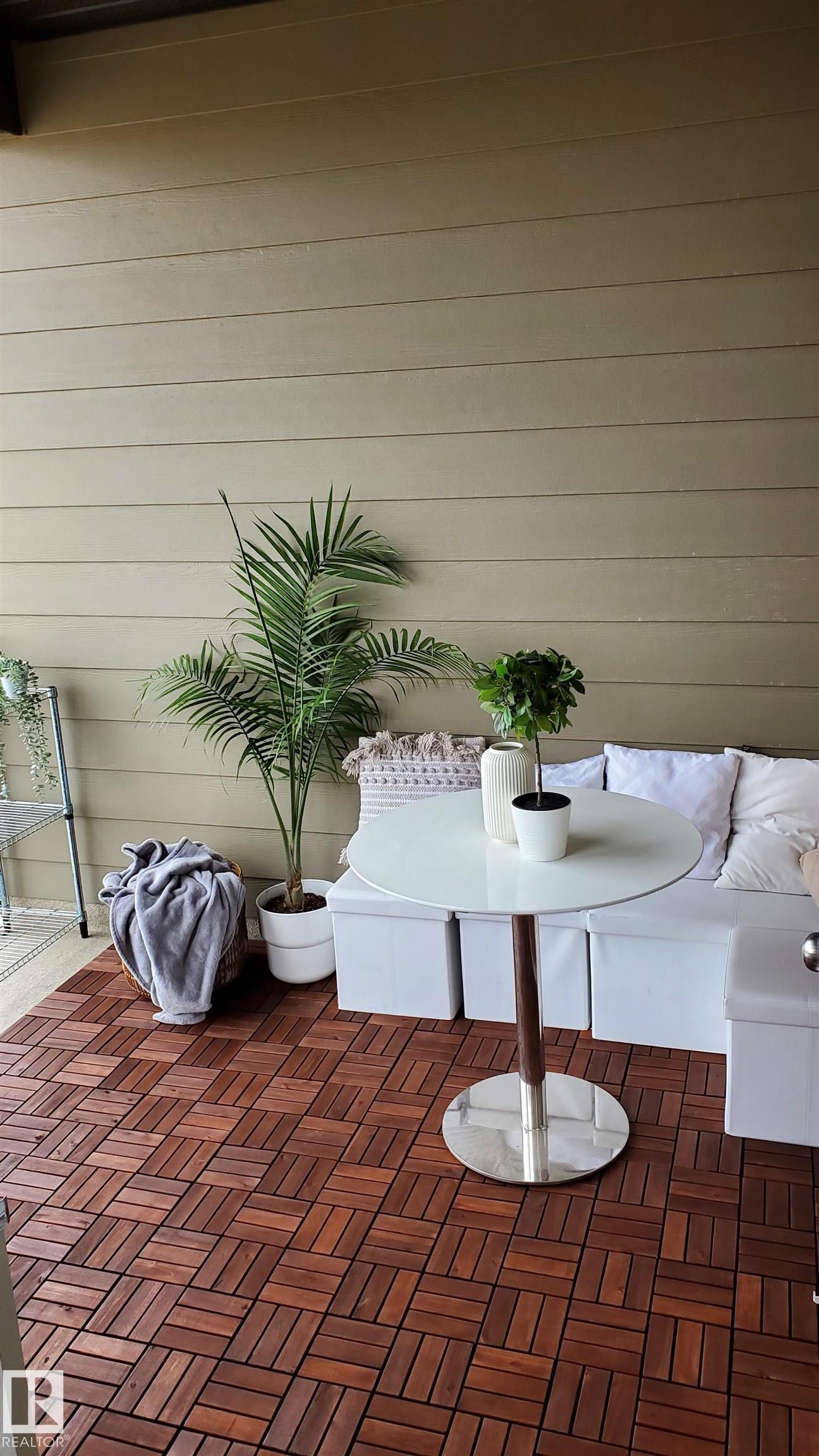 Outdoor living space featuring rich wood-finish flooring - #415 12045 22 Av Sw, Edmonton, AB - With Exterior