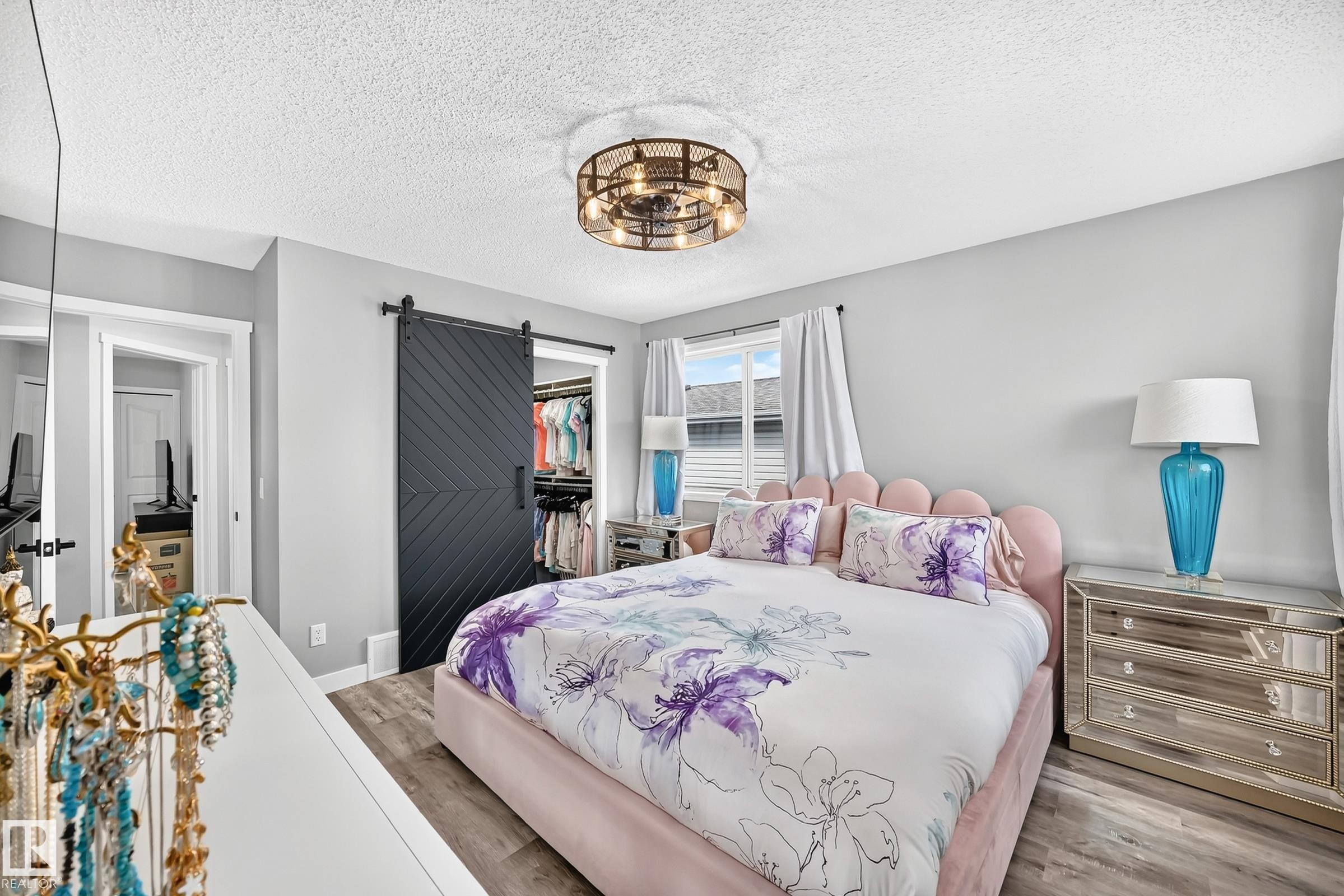 Bedroom featuring wood-finish flooring, a contemporary ceiling light fixture, and a window with blinds - 3729 131A Avenue Nw, Edmonton, AB - Indoor Photo Showing Bedroom