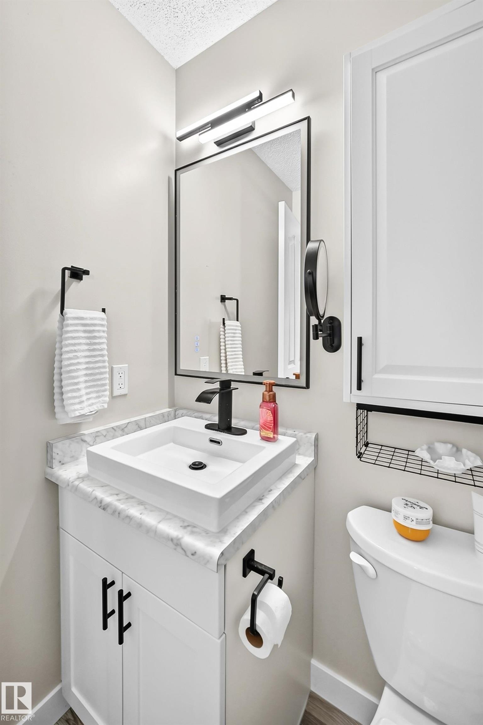 Contemporary vanity featuring a rectangular vessel sink, black faucet, and white countertop - 3729 131A Avenue Nw, Edmonton, AB - Indoor Photo Showing Bathroom