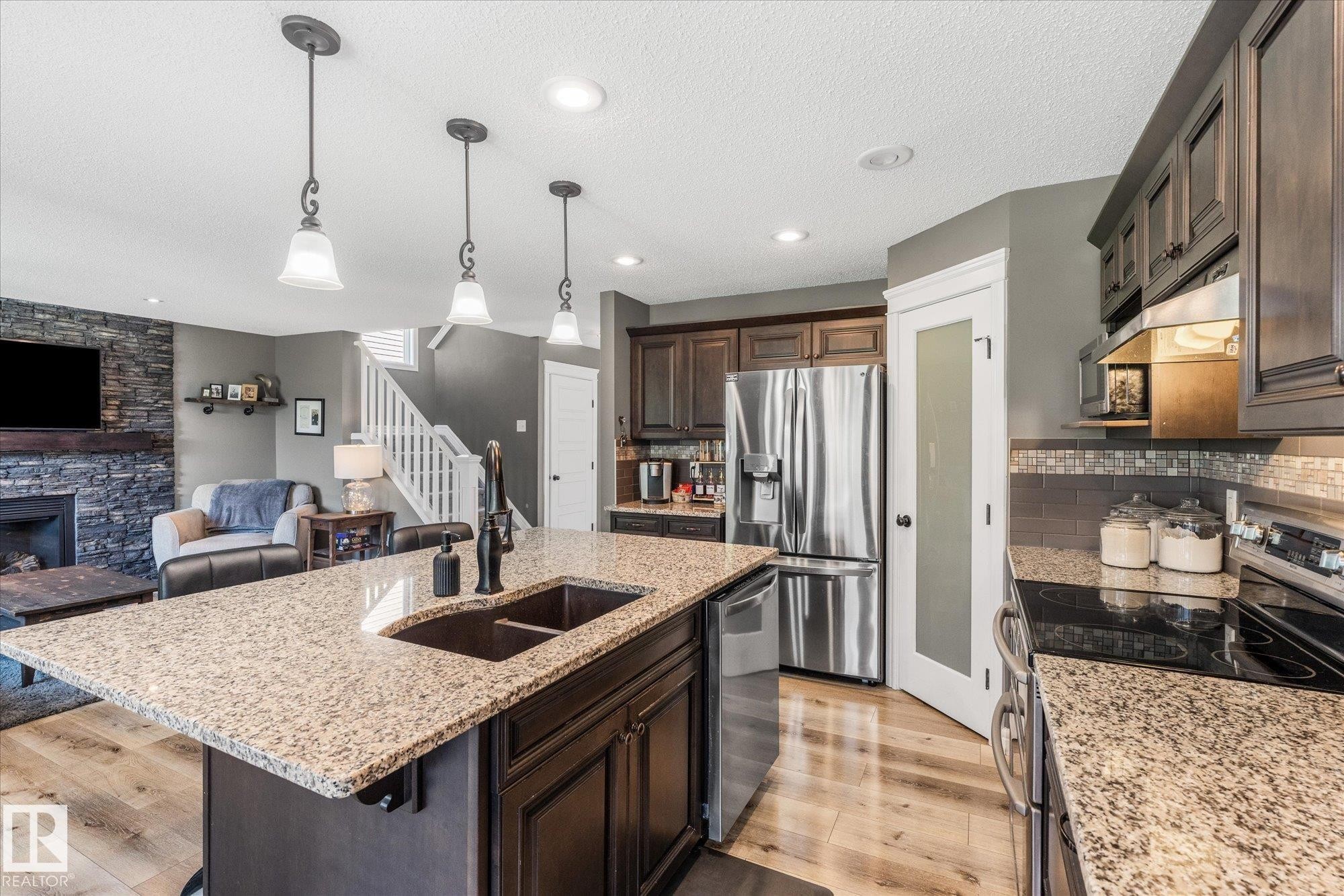 41 Meadowview Landing, Spruce Grove, AB - Indoor Photo Showing Kitchen With Fireplace With Double Sink With Upgraded Kitchen