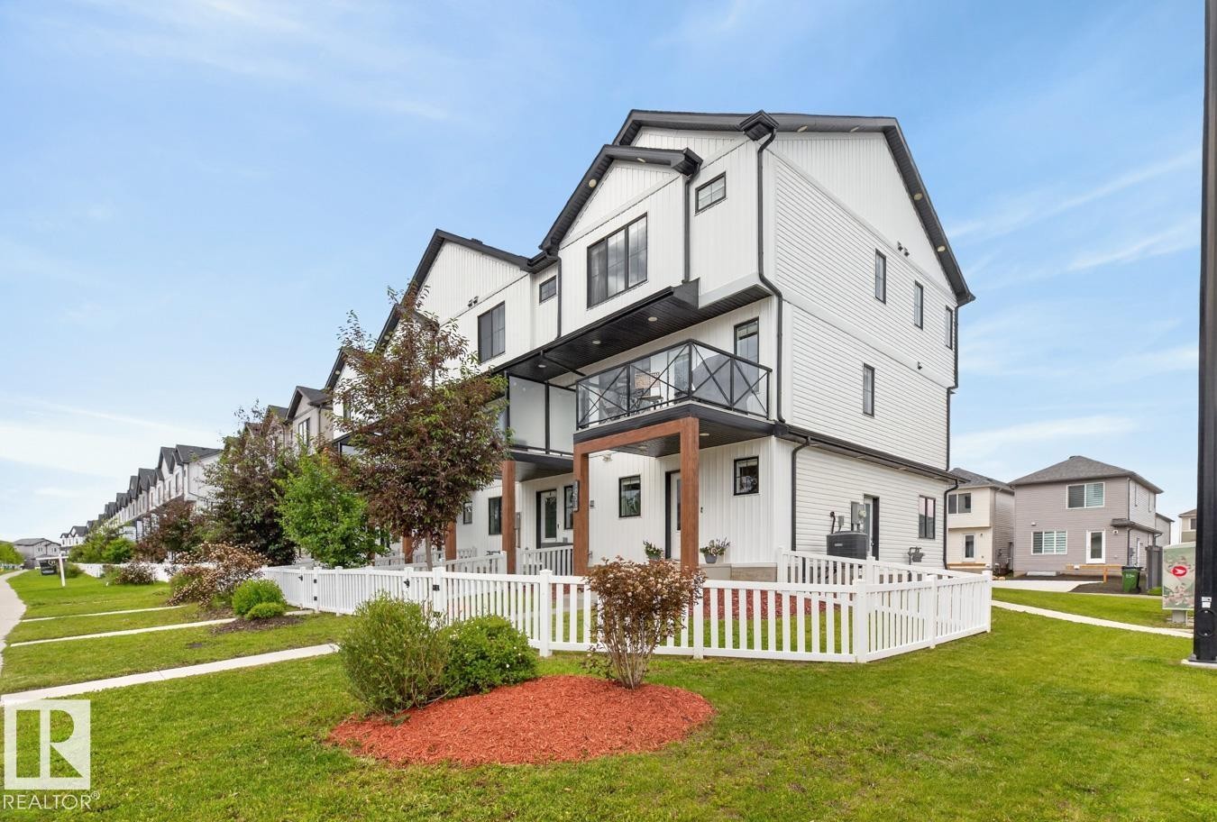 Front of Home located on a Landscaped Corner Lot. Fully Fenced with Front and Side Entrance. - 1051 Cy Becker Road Nw, Edmonton, AB - Outdoor With Balcony