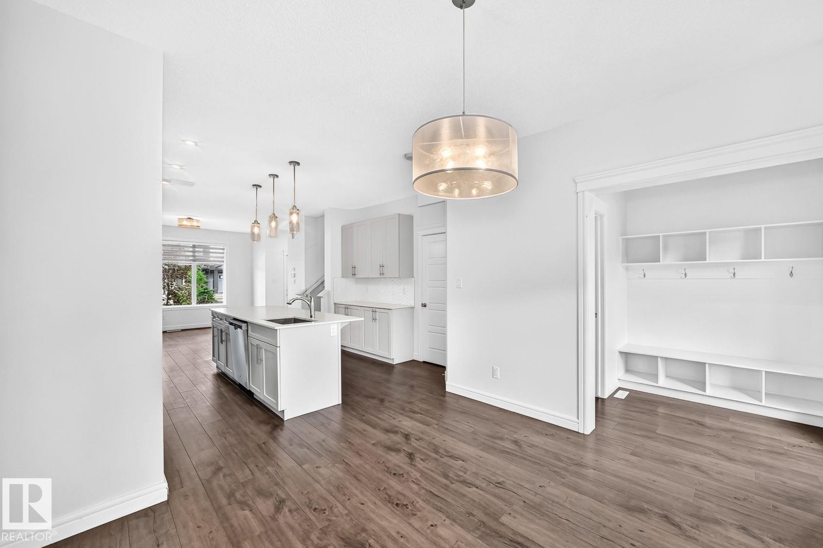 Open-concept main living area featuring wood-finish flooring throughout - 1261 Rosenthal Boulevard Nw, Edmonton, AB - Indoor Photo Showing Other Room