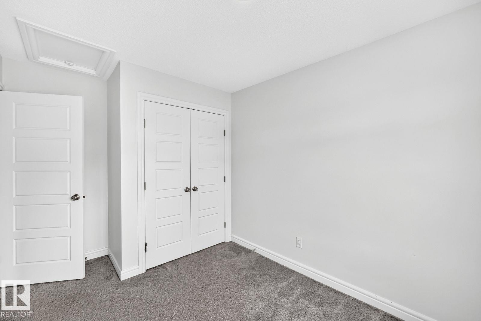 Neutral wall paint with textured carpeting - 1261 Rosenthal Boulevard Nw, Edmonton, AB - Indoor Photo Showing Other Room