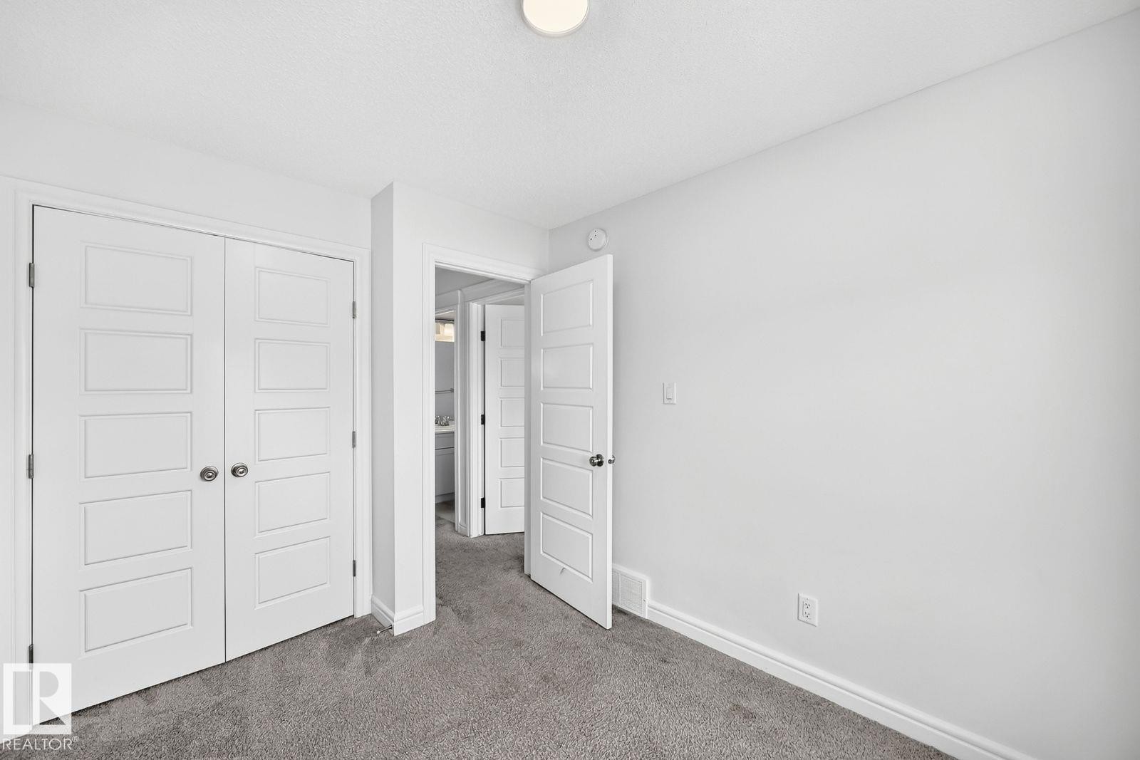 Bedroom featuring gray carpet flooring, white walls, and a ceiling-mounted light fixture - 1261 Rosenthal Boulevard Nw, Edmonton, AB - Indoor Photo Showing Other Room