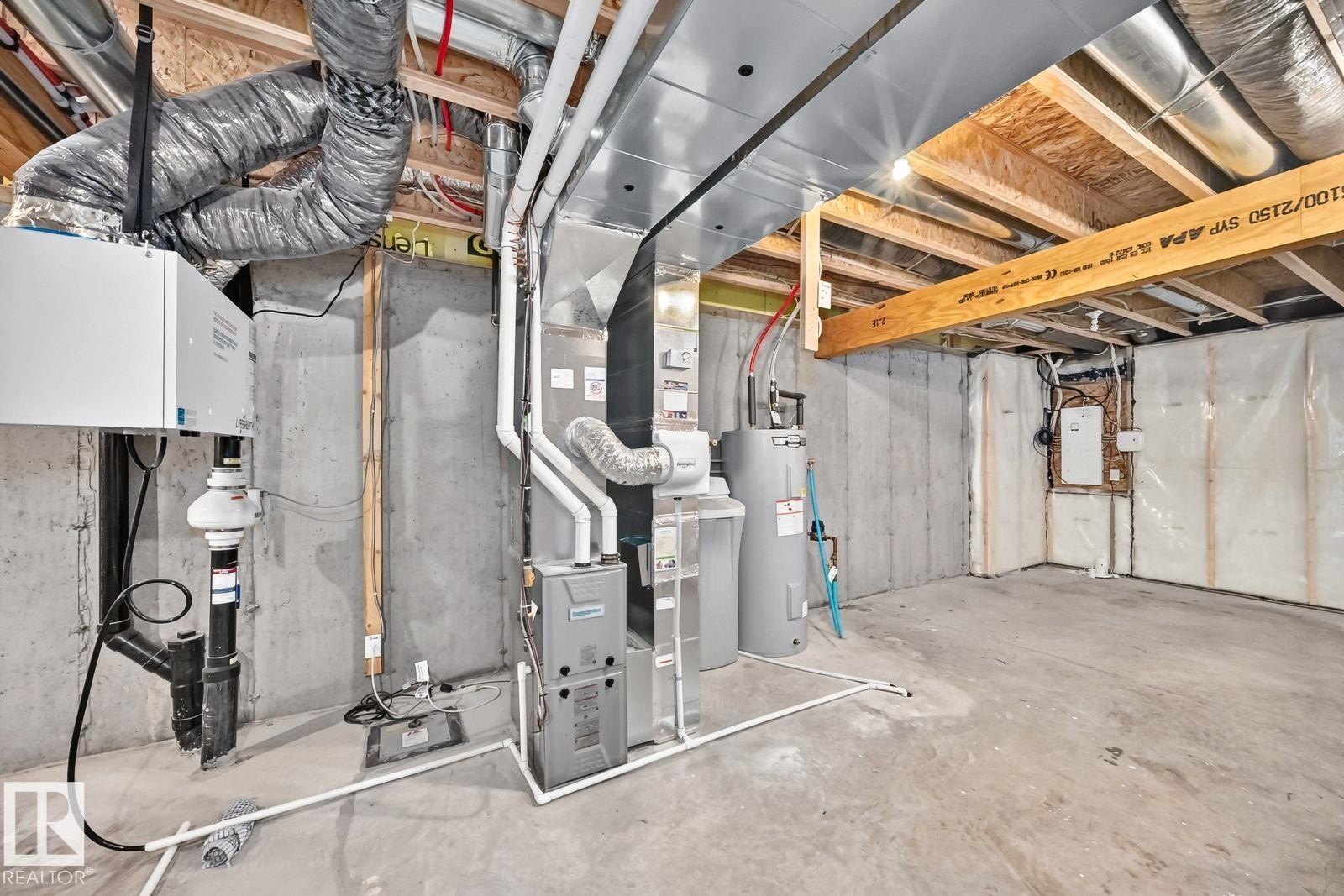 Unfinished basement featuring concrete walls and flooring, exposed ceiling joists, HVAC ductwork, water heater, and furnace - 1261 Rosenthal Boulevard Nw, Edmonton, AB - Indoor Photo Showing Basement