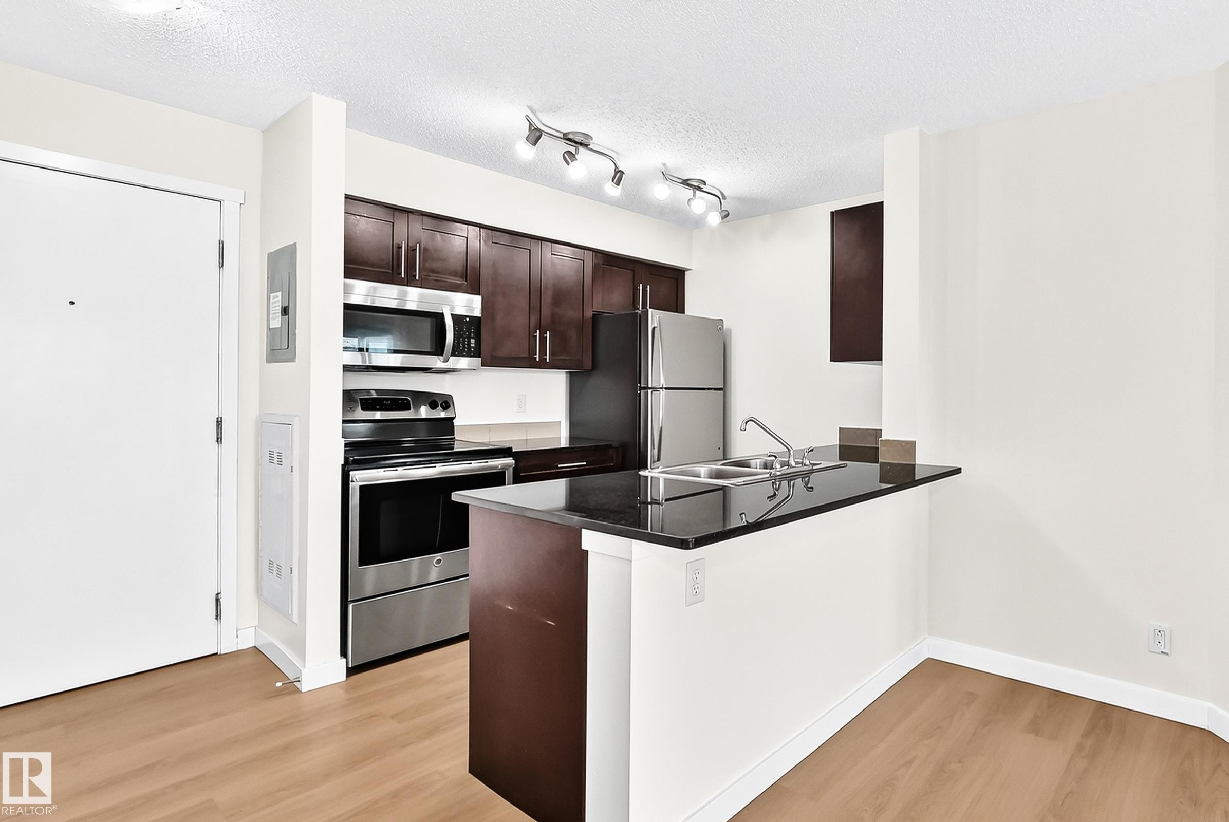 #206 3315 James Mowatt Tr Sw, Edmonton, AB - Indoor Photo Showing Kitchen With Double Sink
