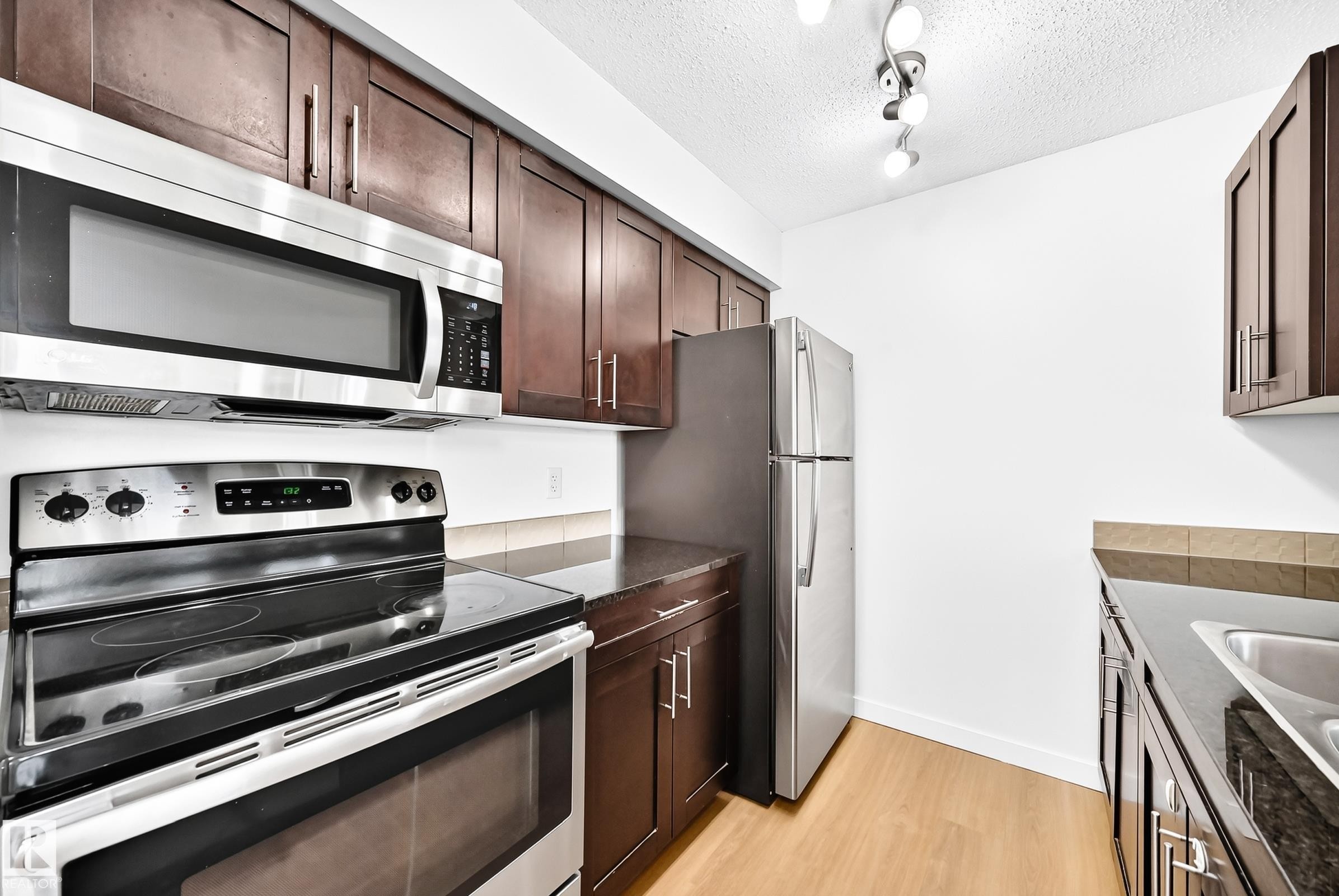 #206 3315 James Mowatt Tr Sw, Edmonton, AB - Indoor Photo Showing Kitchen With Double Sink