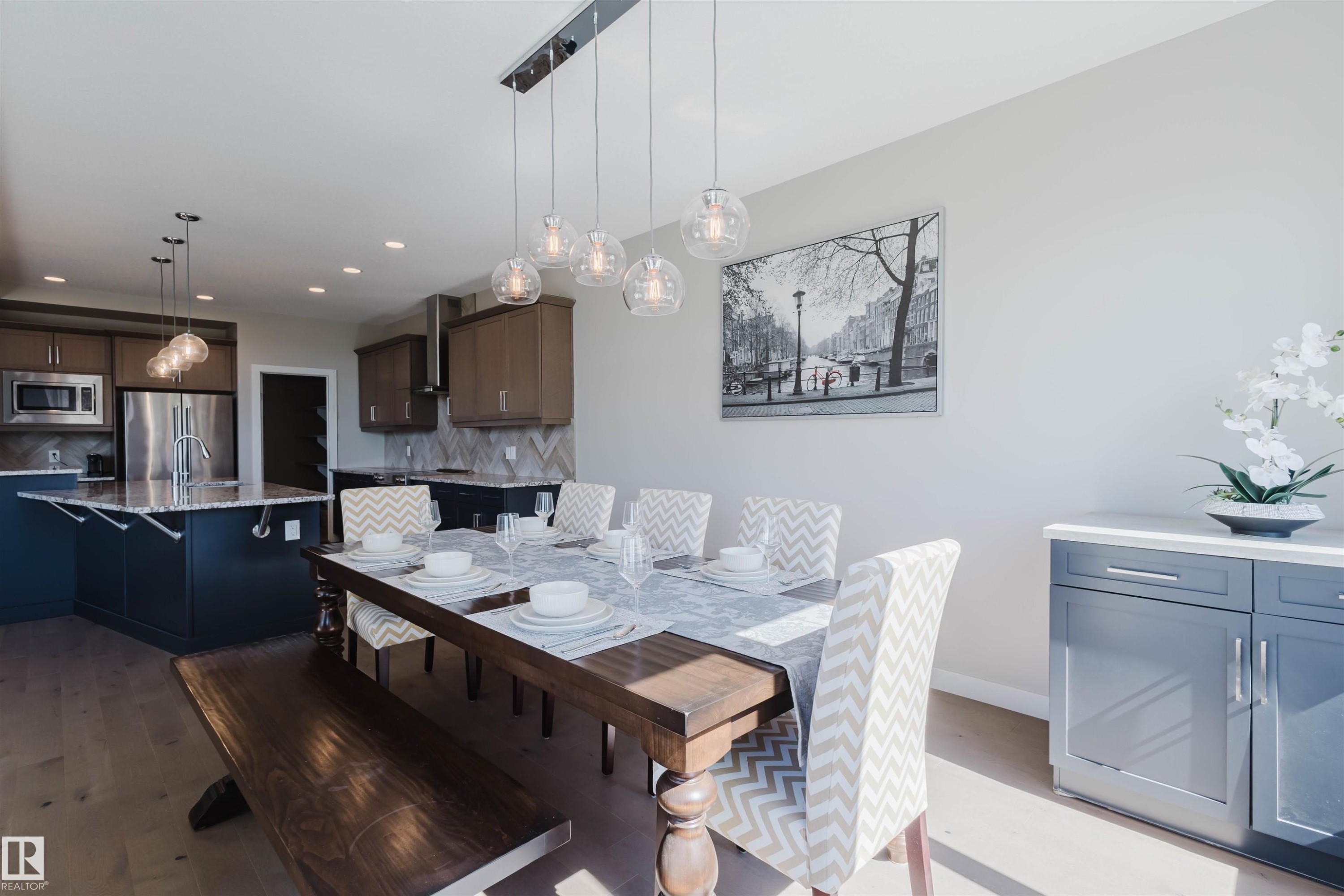 Spacious open-concept interior featuring light wood-finish flooring - 4125 Kennedy Green Sw, Edmonton, AB - Indoor