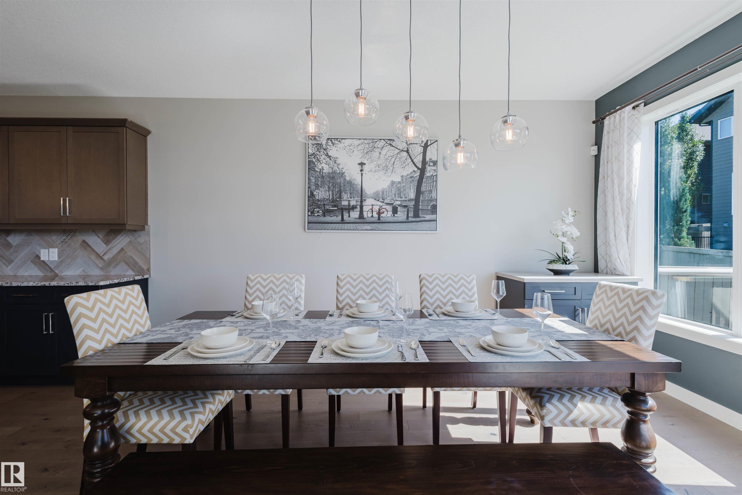 Dining area featuring a dark wood-finish table and coordinated bench seating - 4125 Kennedy Green Sw, Edmonton, AB - Indoor Photo Showing Dining Room