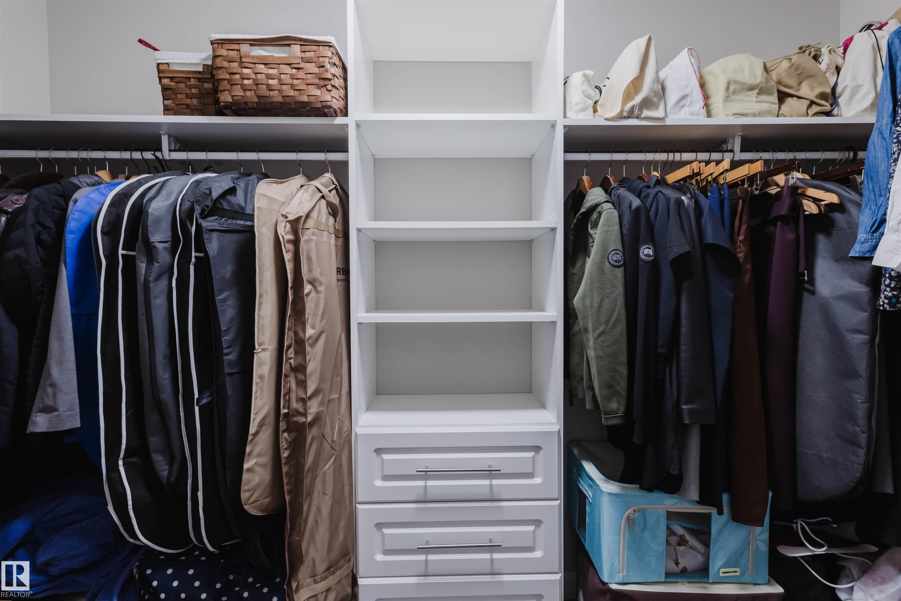Custom closet system featuring central shelving unit with integrated drawers - 4125 Kennedy Green Sw, Edmonton, AB - Indoor With Storage