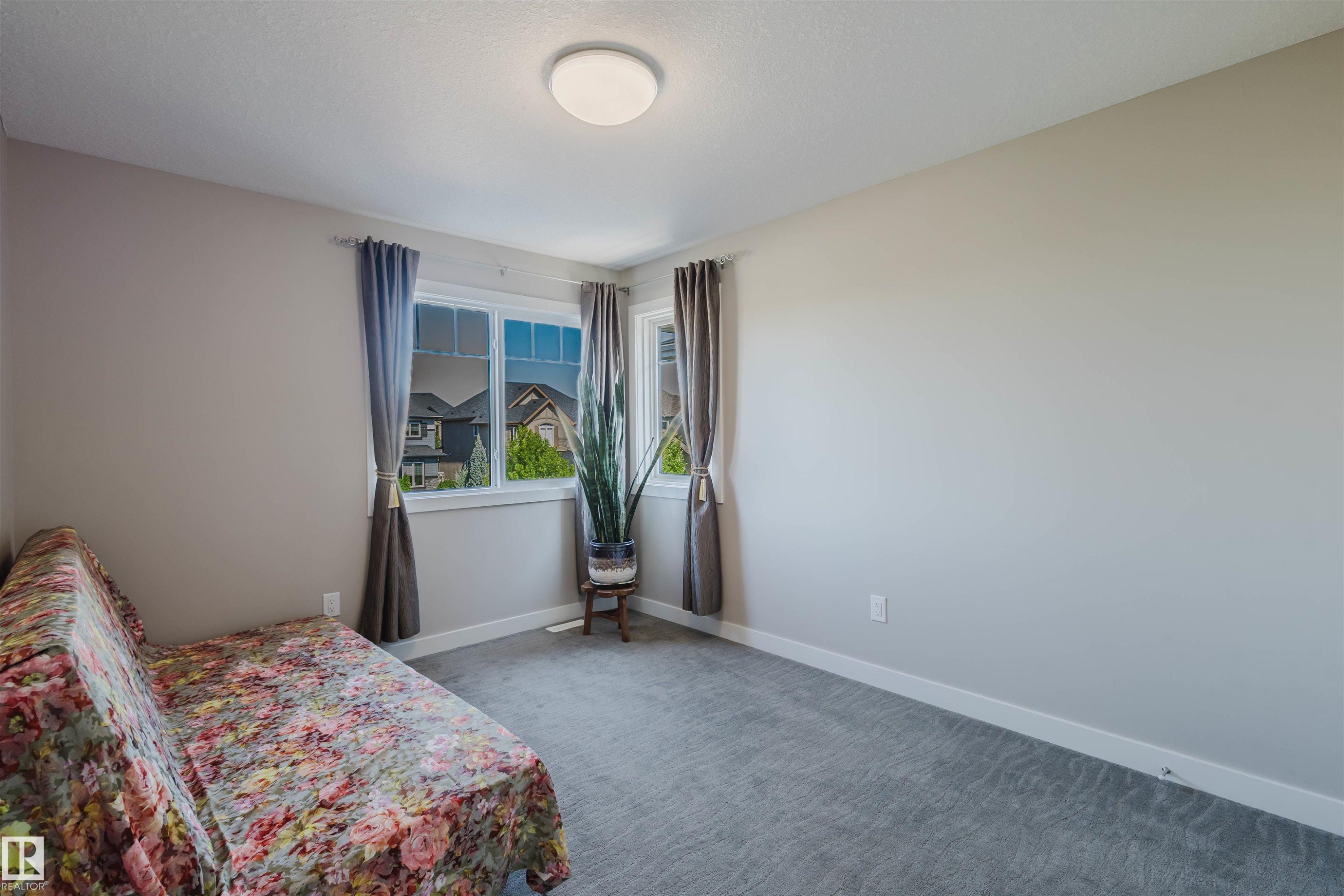 Room featuring light gray carpet, neutral wall paint, and white trim - 4125 Kennedy Green Sw, Edmonton, AB - Indoor Photo Showing Bedroom