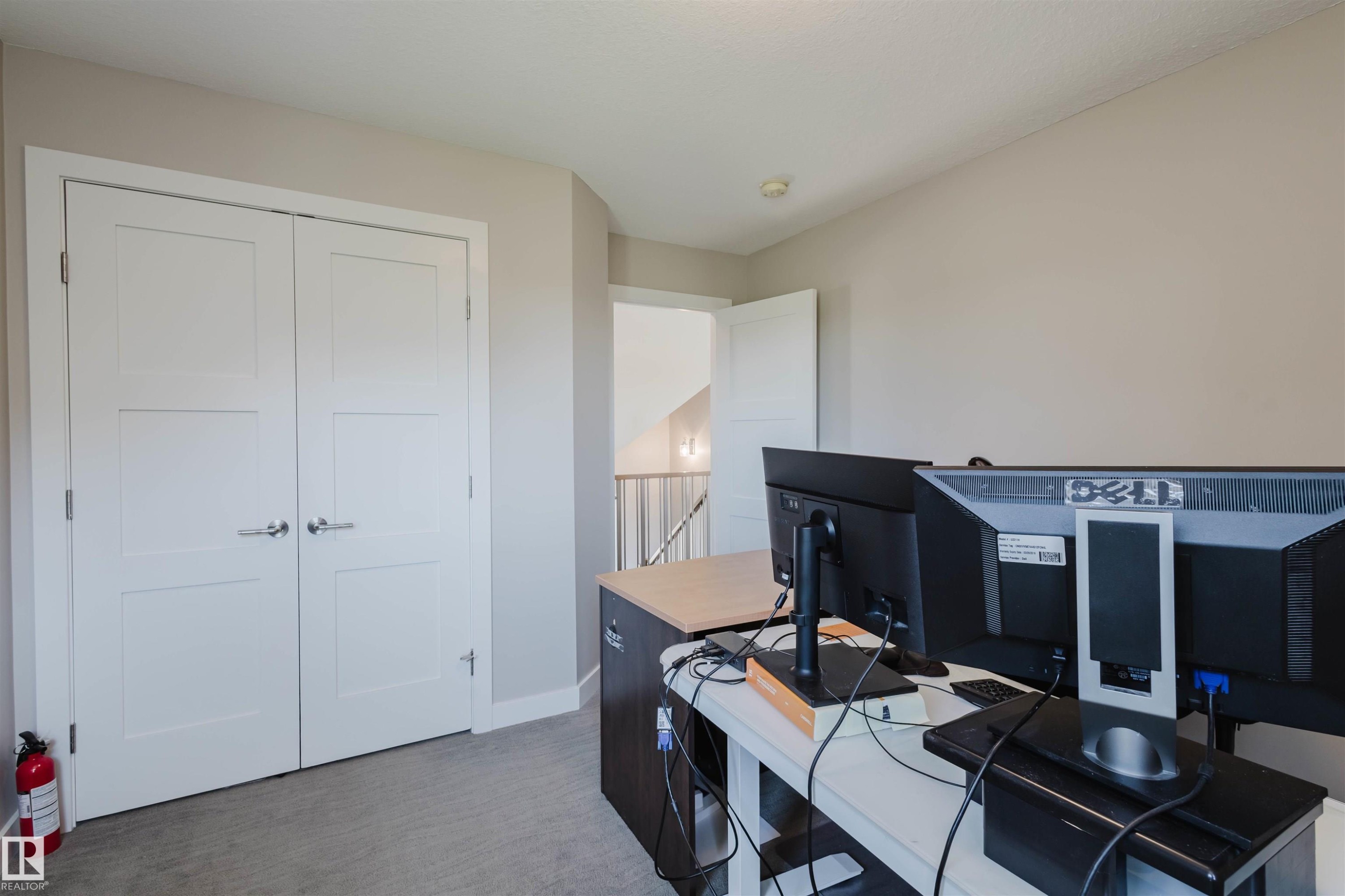 Neutral wall paint finishes, crisp white trim, and light grey carpet flooring - 4125 Kennedy Green Sw, Edmonton, AB - Indoor Photo Showing Office