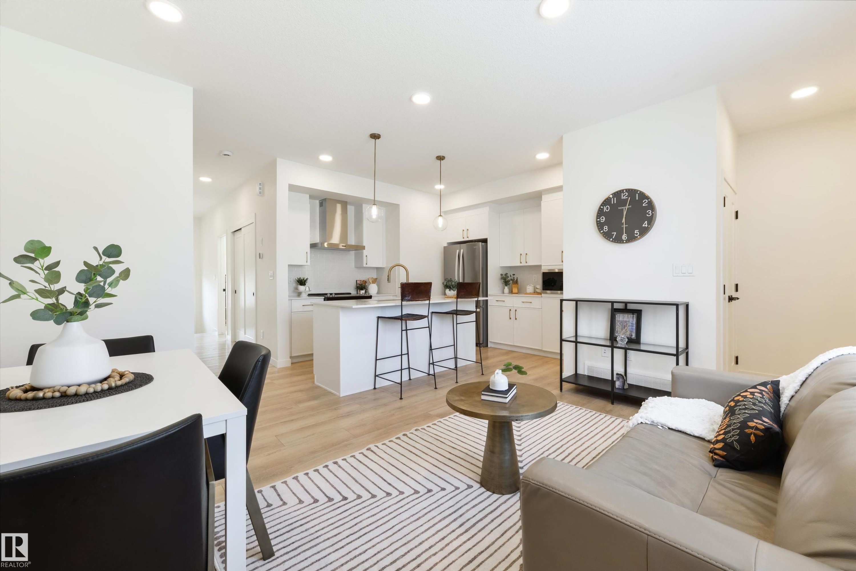 Open-concept living space featuring wood-finish flooring and recessed lighting - 323 Rankin Drive, St. Albert, AB - Indoor