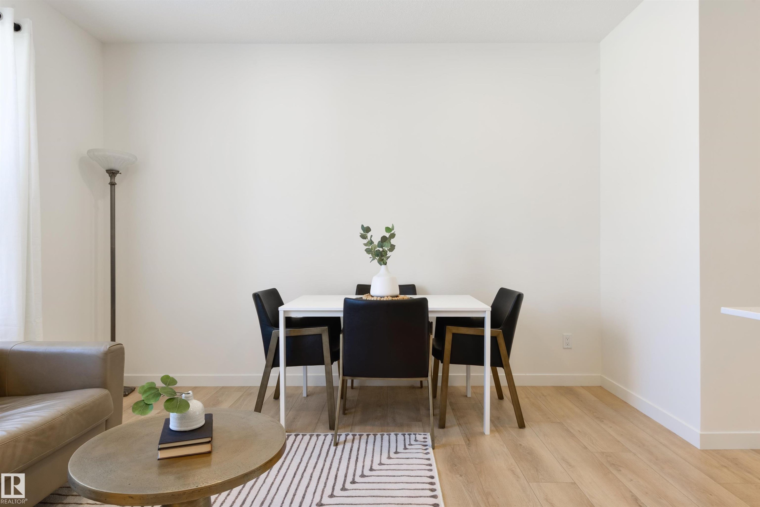 Open-concept living space featuring wood-finish flooring, white walls, and bright natural light from a window - 323 Rankin Drive, St. Albert, AB - Indoor Photo Showing Dining Room