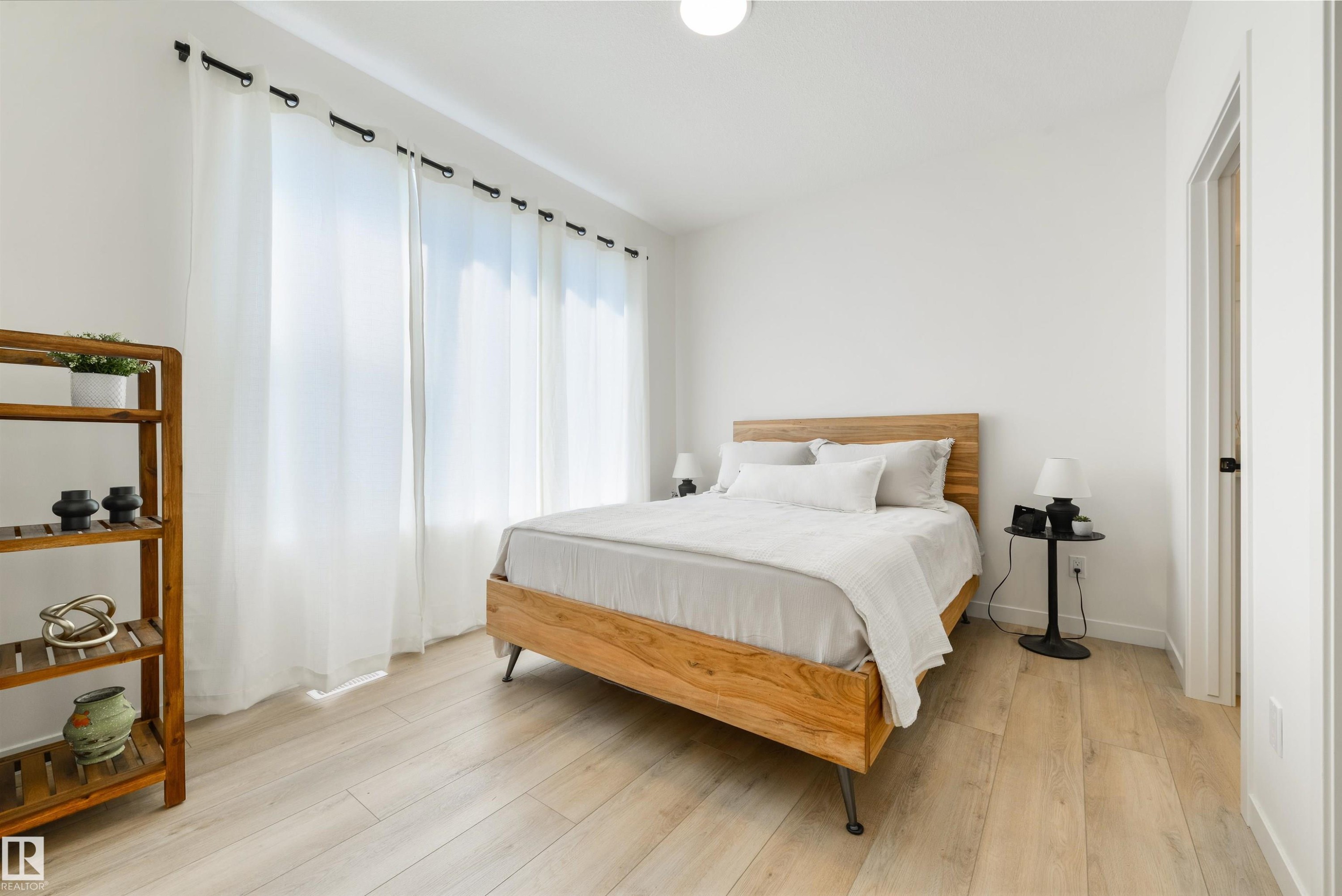 Bright interior with light wood-finish flooring - 323 Rankin Drive, St. Albert, AB - Indoor Photo Showing Bedroom