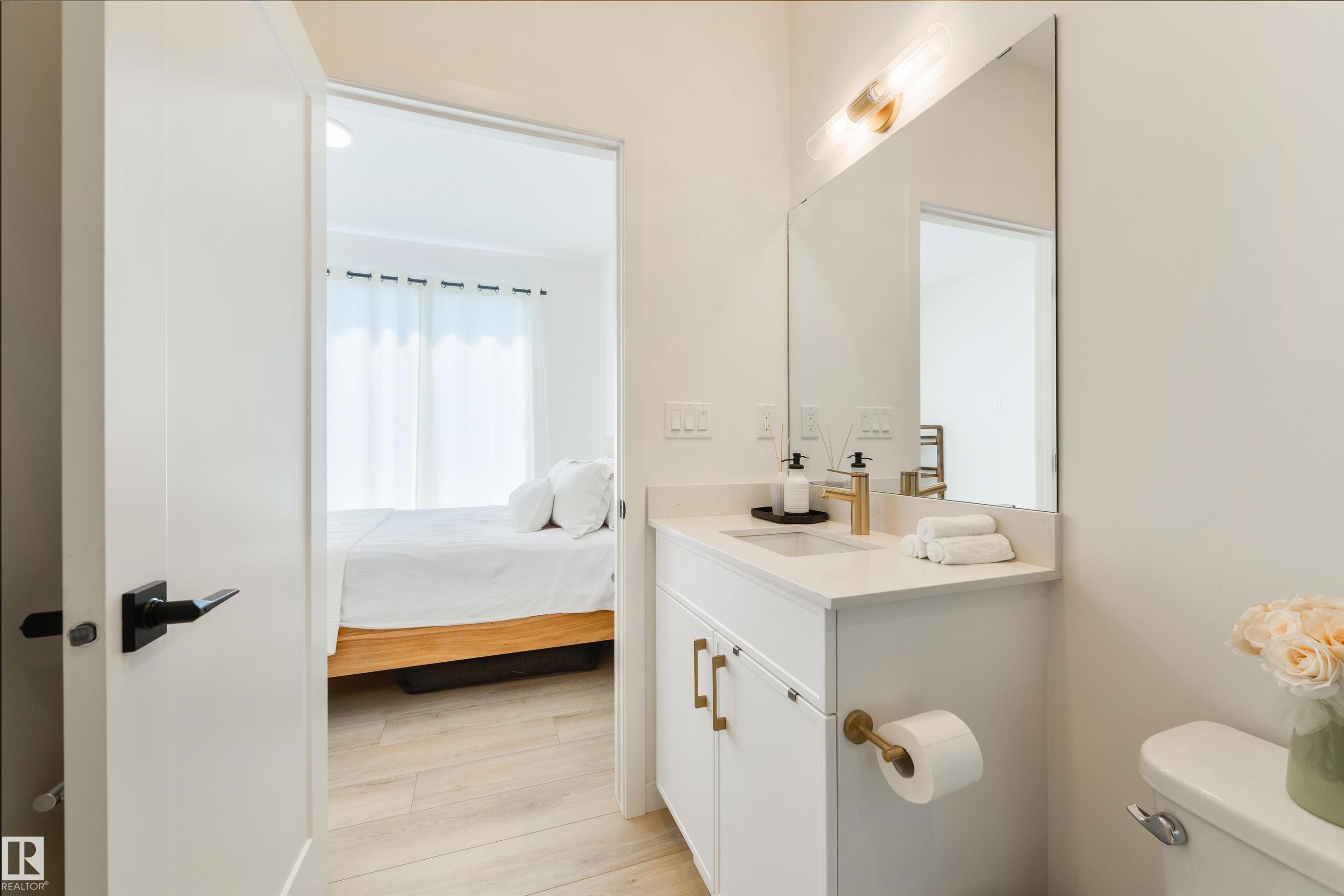 Modern bathroom vanity with a single basin, quartz countertop, and gold-finish fixtures - 323 Rankin Drive, St. Albert, AB - Indoor Photo Showing Bathroom