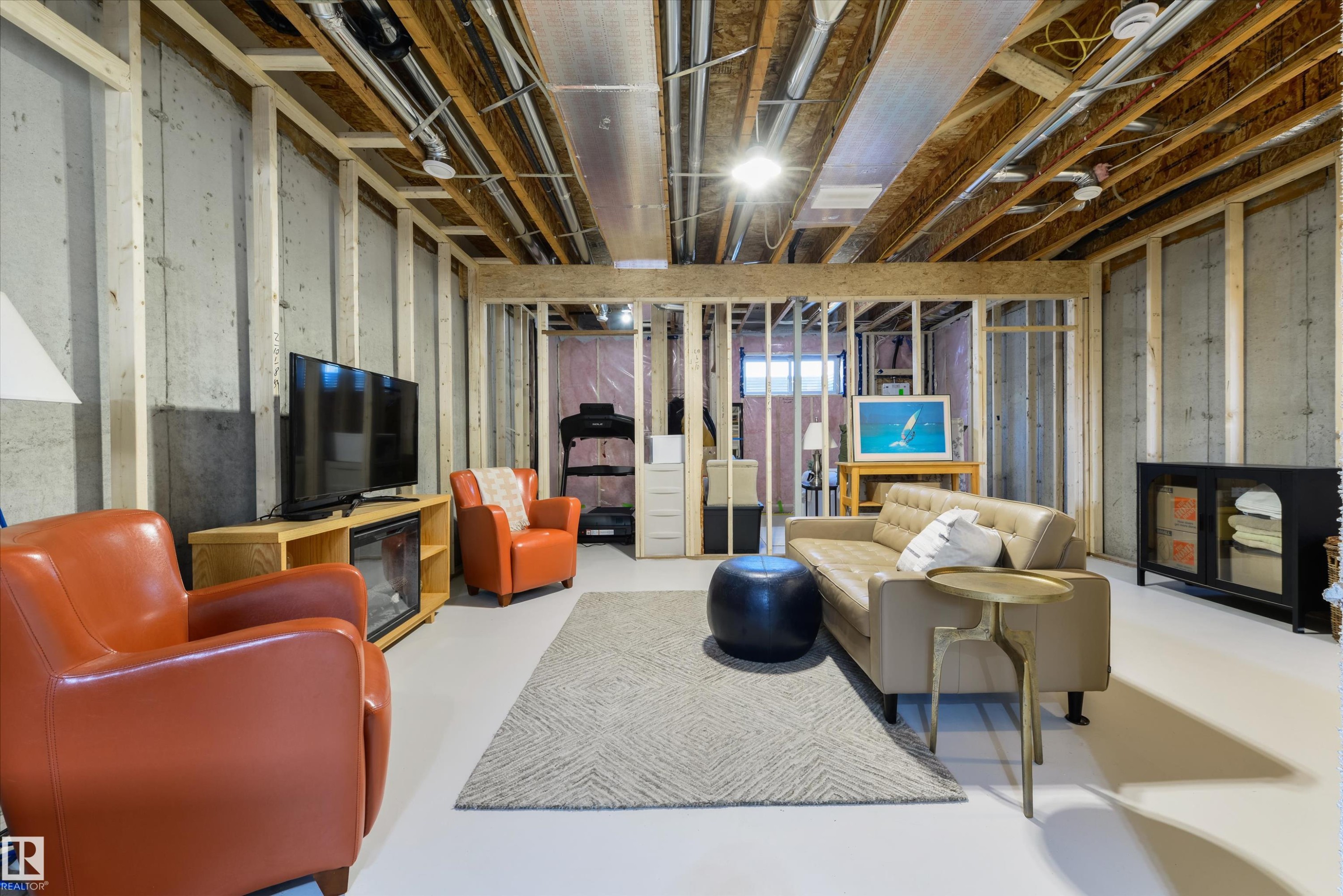 Unfinished basement featuring exposed wood framing, concrete walls, and overhead utility lines - 323 Rankin Drive, St. Albert, AB - Indoor Photo Showing Basement