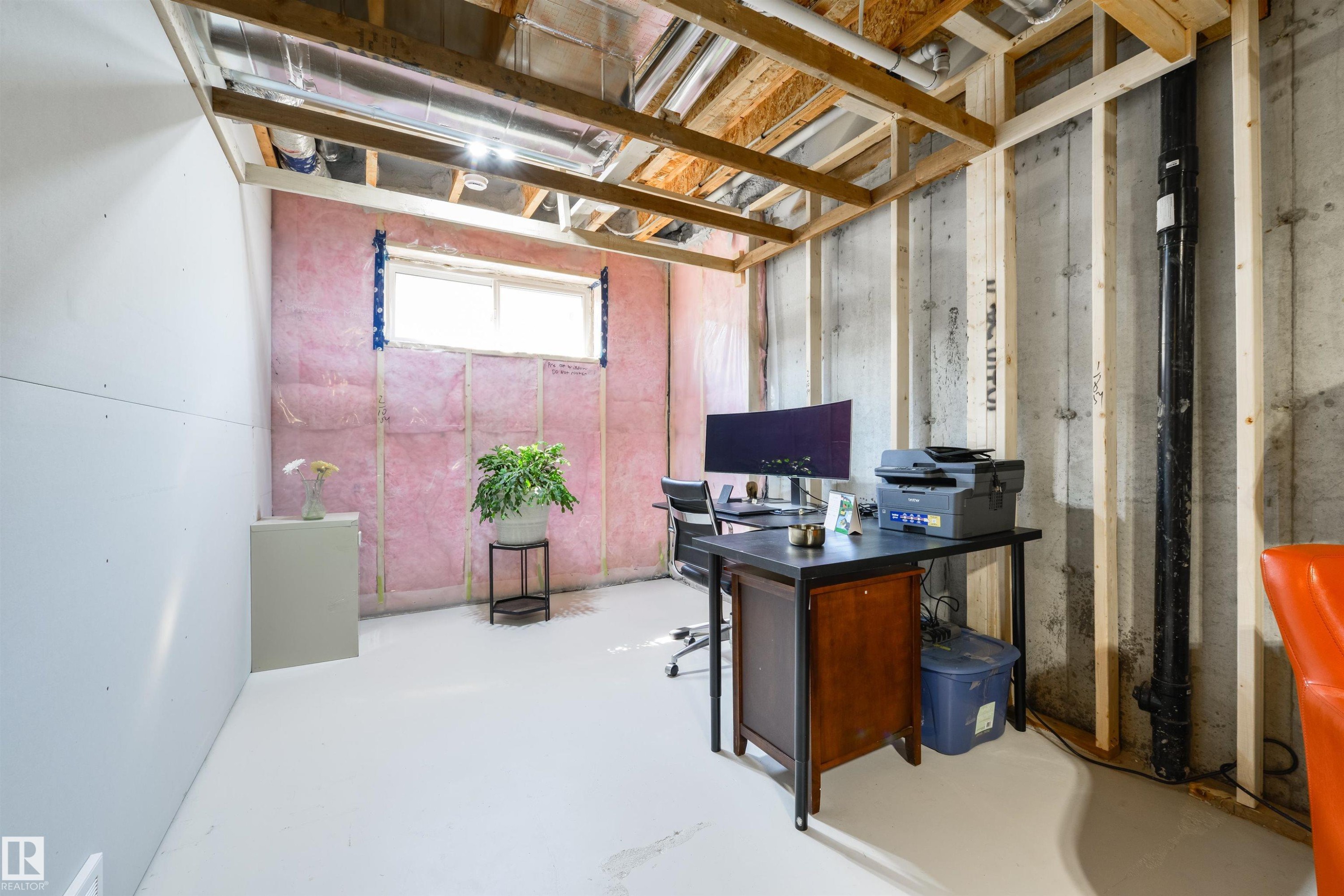 Unfinished basement featuring exposed wood joists, concrete foundation walls, a window opening, and visible insulation - 323 Rankin Drive, St. Albert, AB - Indoor Photo Showing Basement