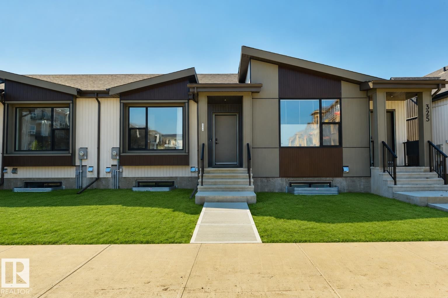 Modern facade featuring a mix of horizontal siding and paneling, with a prominent A-frame architectural element - 323 Rankin Drive, St. Albert, AB - Outdoor With Facade