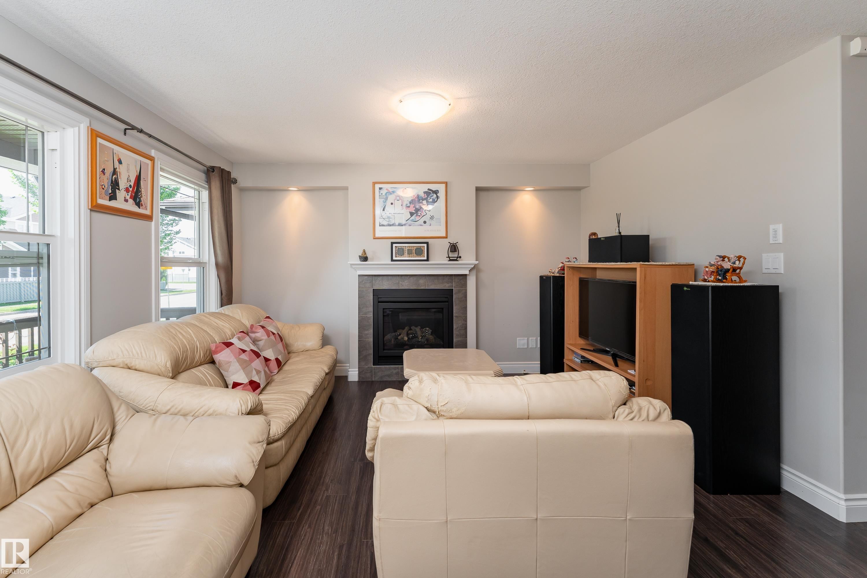 2338 Glenridding Boulevard Sw, Edmonton, AB - Indoor Photo Showing Living Room With Fireplace