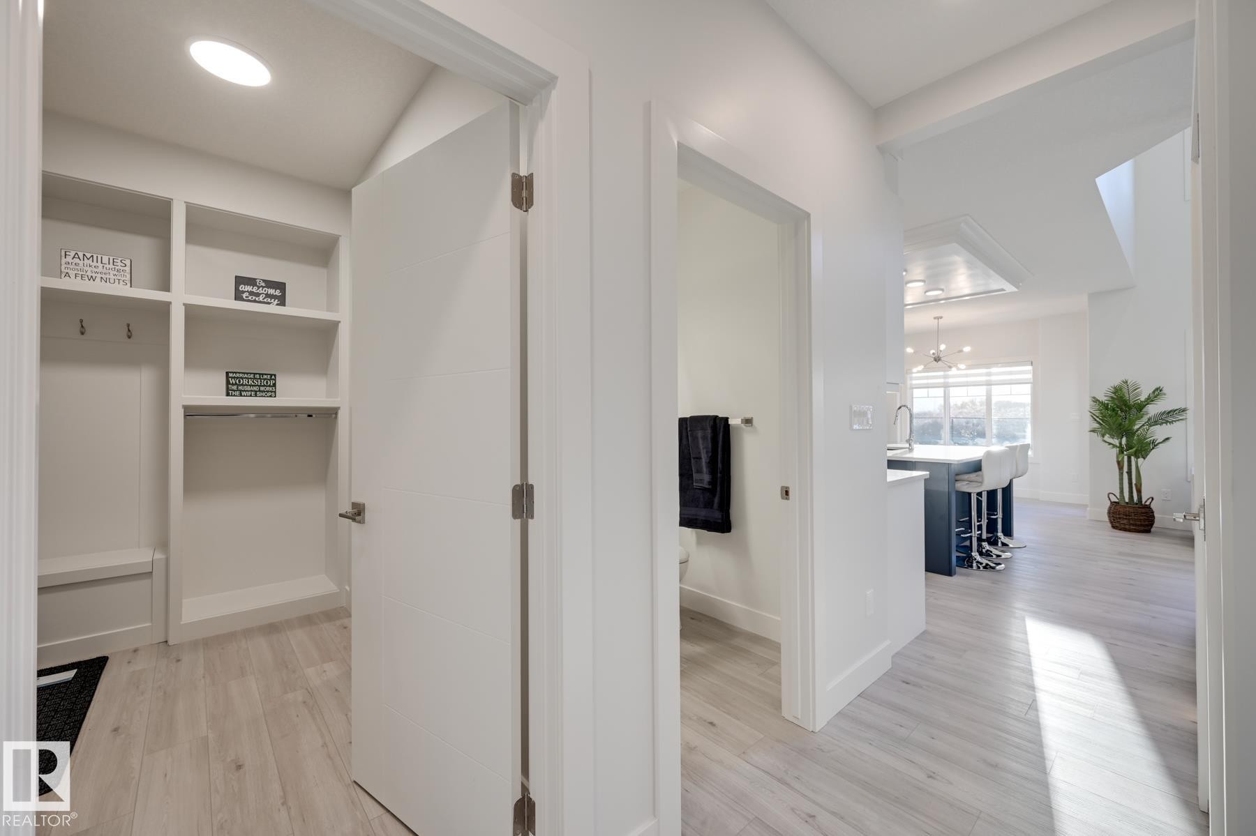 Entryway featuring wood-finish flooring extending into the main living spaces - 1776 Crossbill Loop Nw, Edmonton, AB - Indoor Photo Showing Other Room