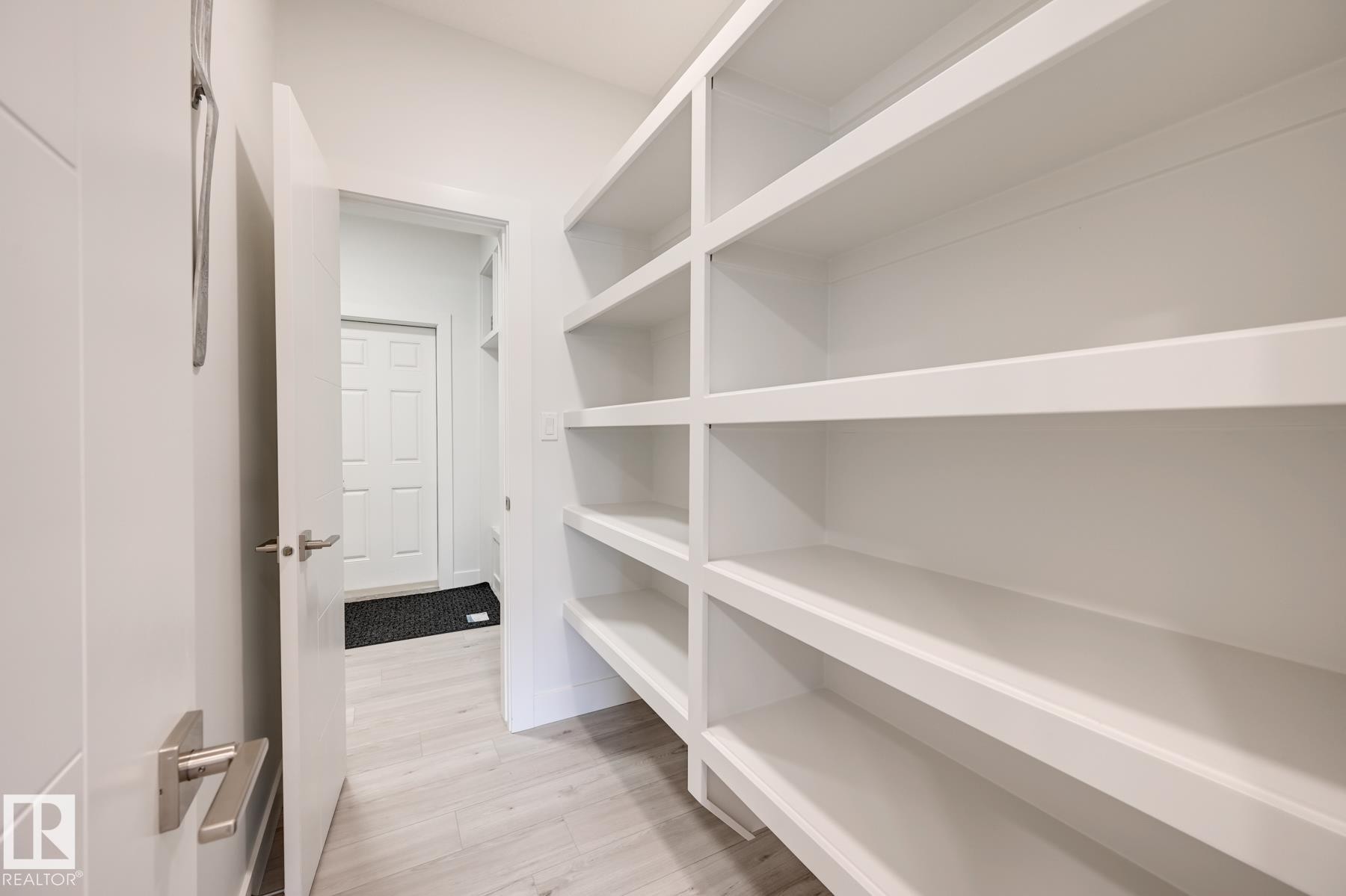 Custom built-in shelving with multiple levels of storage - 1776 Crossbill Loop Nw, Edmonton, AB - Indoor With Storage