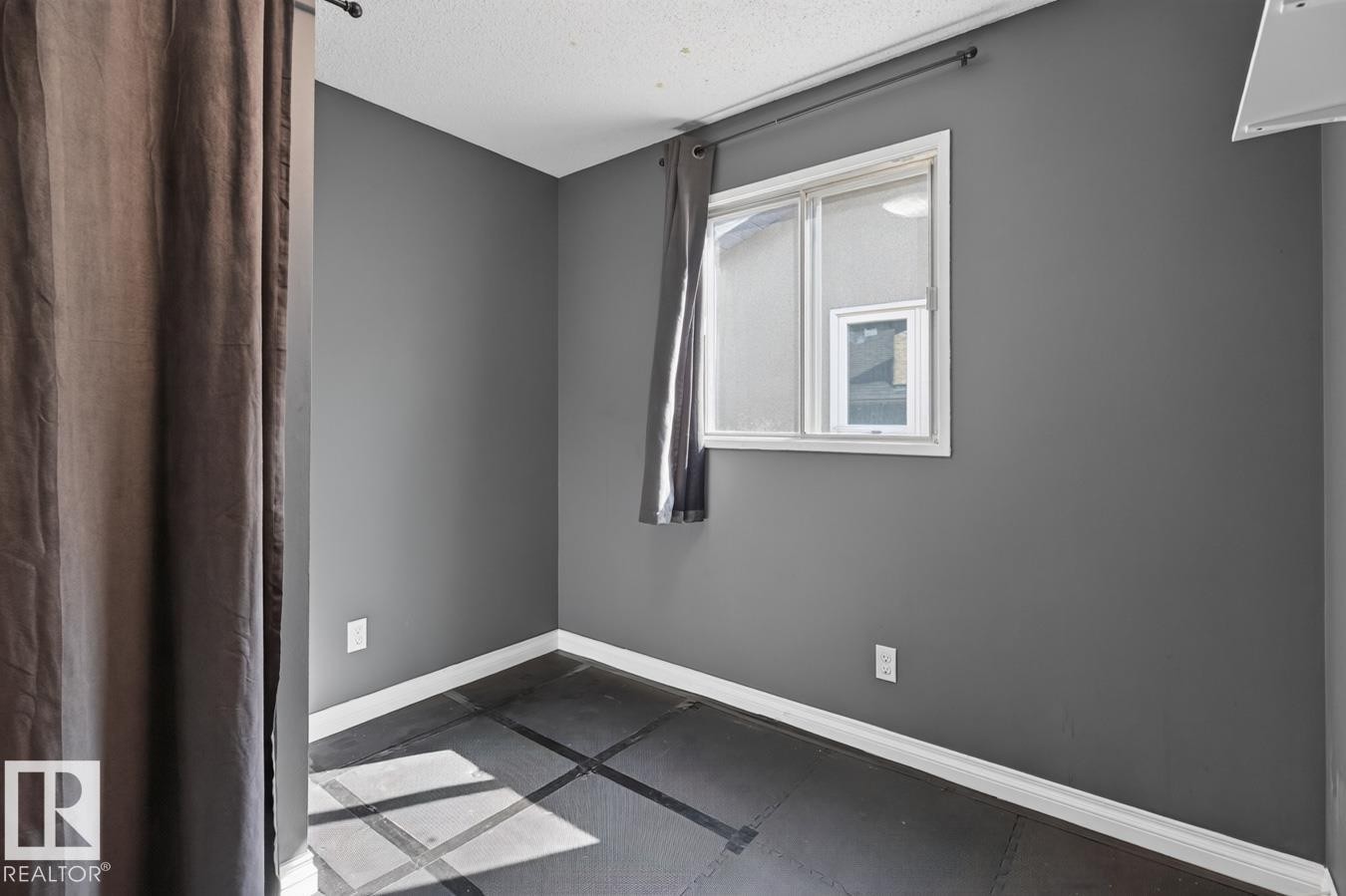 Windowed room featuring dark gray walls and white trim - 4003 41 Avenue Nw, Edmonton, AB - Indoor Photo Showing Other Room