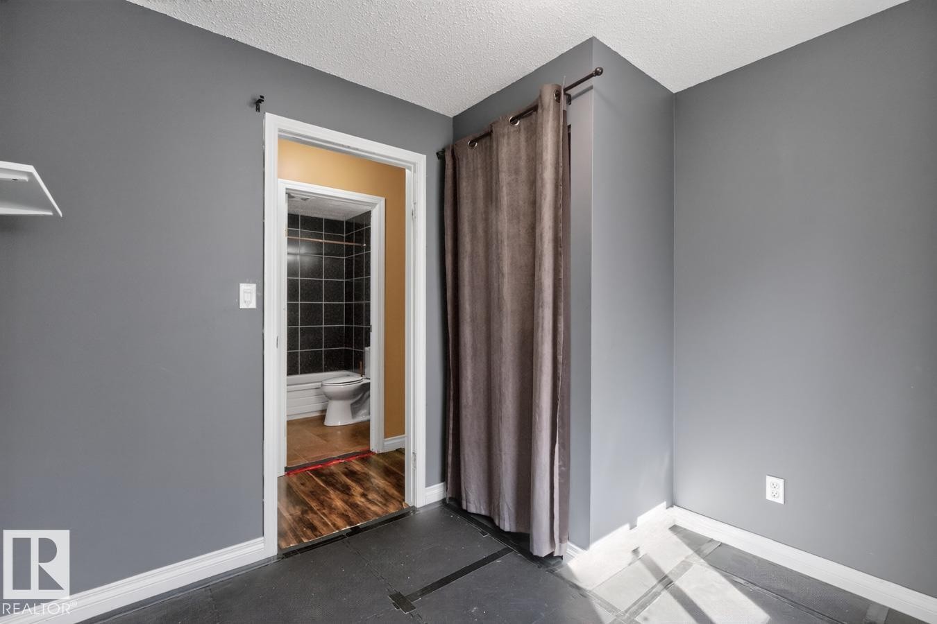 Interior space featuring gray walls, white trim, and dark flooring - 4003 41 Avenue Nw, Edmonton, AB - Indoor Photo Showing Other Room