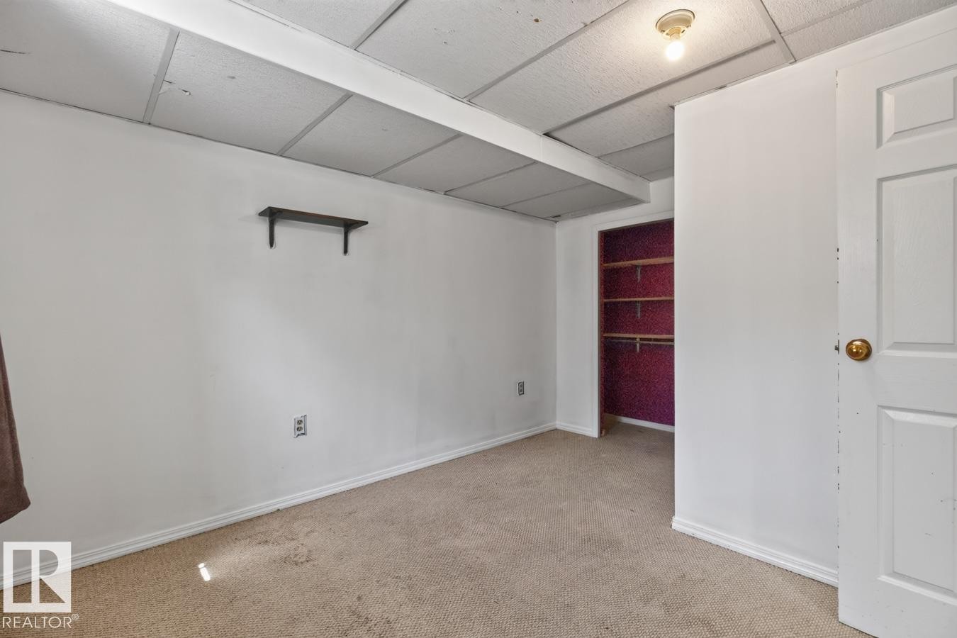 Carpeted interior space with a drop ceiling, white walls, and white trim - 4003 41 Avenue Nw, Edmonton, AB - Indoor Photo Showing Other Room