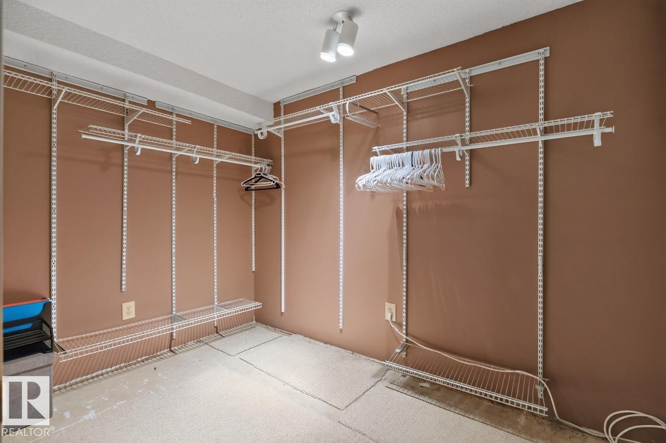 Walk-in closet featuring adjustable wire shelving and hanging rods - 4003 41 Avenue Nw, Edmonton, AB - Indoor