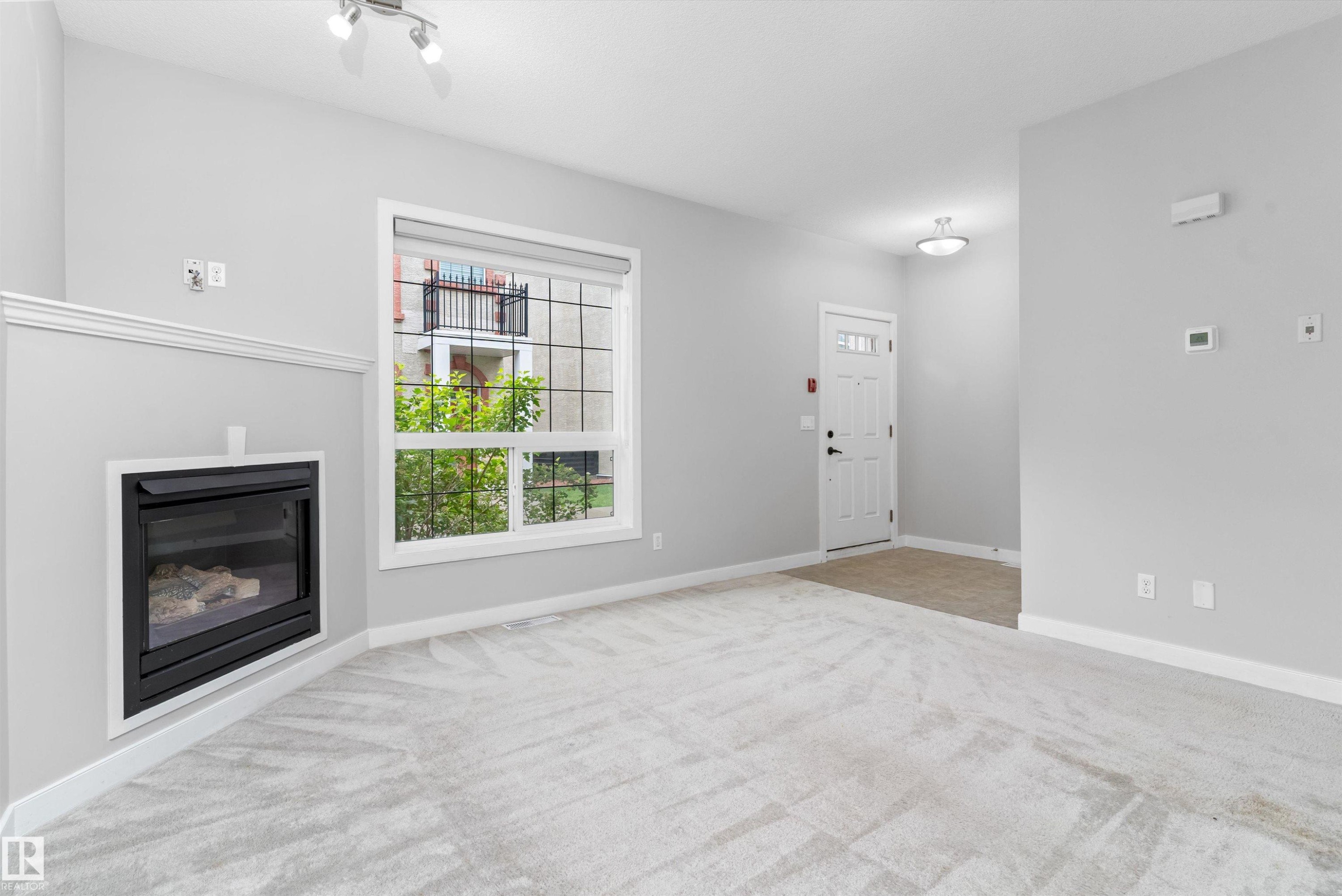 #7 13825 155 Av Nw, Edmonton, AB - Indoor Photo Showing Other Room With Fireplace