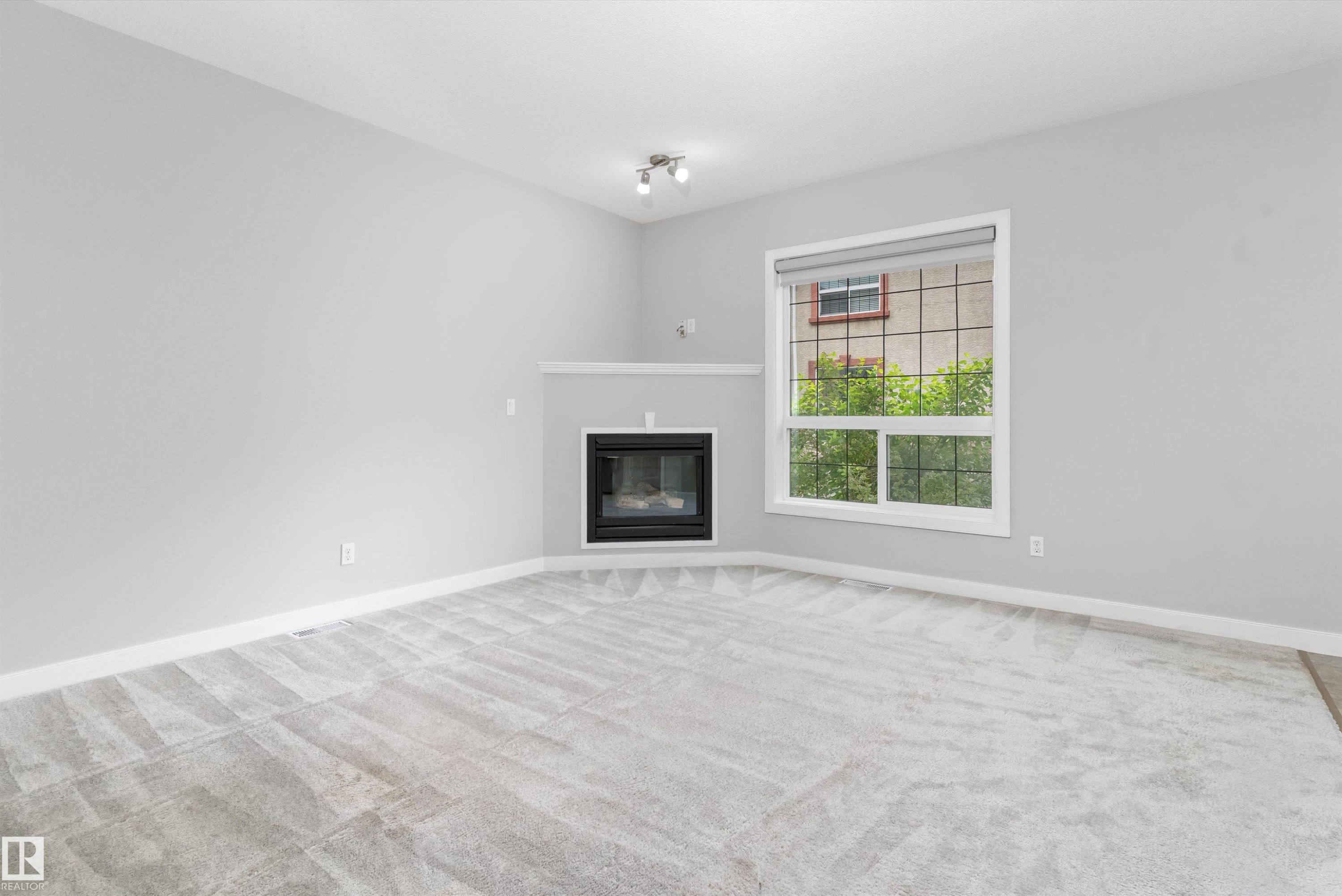 #7 13825 155 Av Nw, Edmonton, AB - Indoor Photo Showing Living Room With Fireplace
