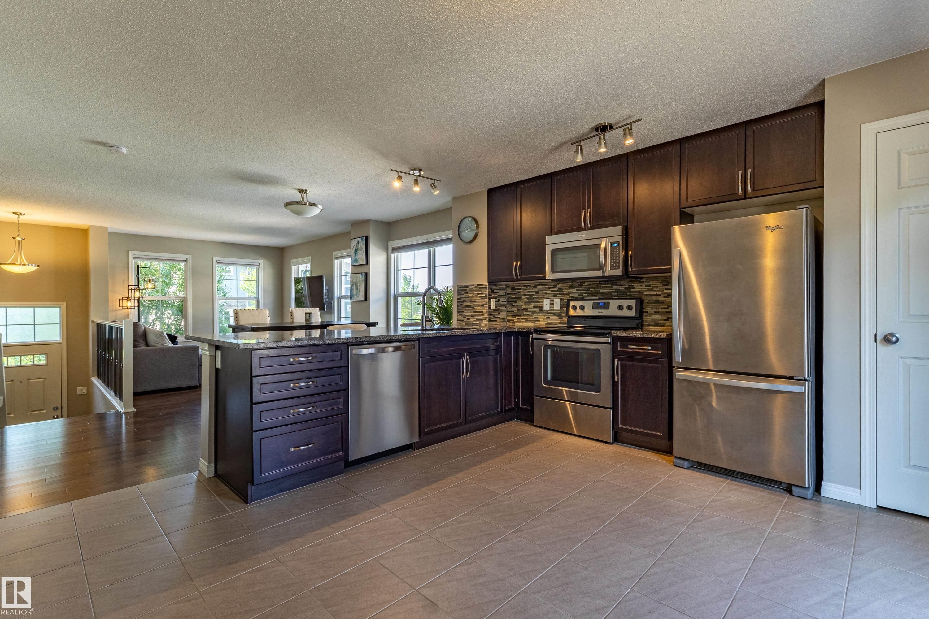 #54 4029 Orchards Dr Sw, Edmonton, AB - Indoor Photo Showing Kitchen With Stainless Steel Kitchen