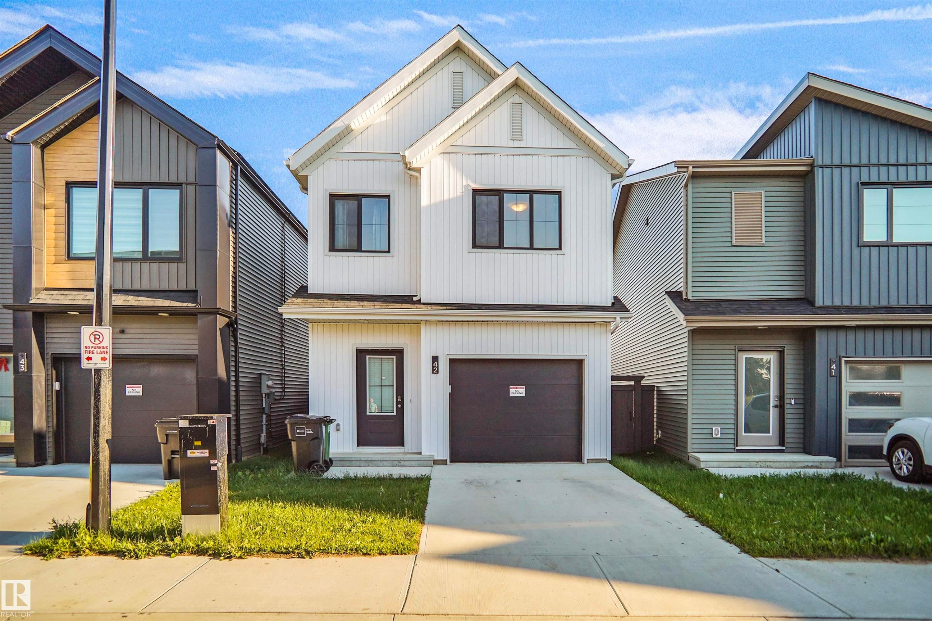 Contemporary two-story residence featuring a white vertical siding facade - #42 19904 31 Av Nw, Edmonton, AB - Outdoor With Facade