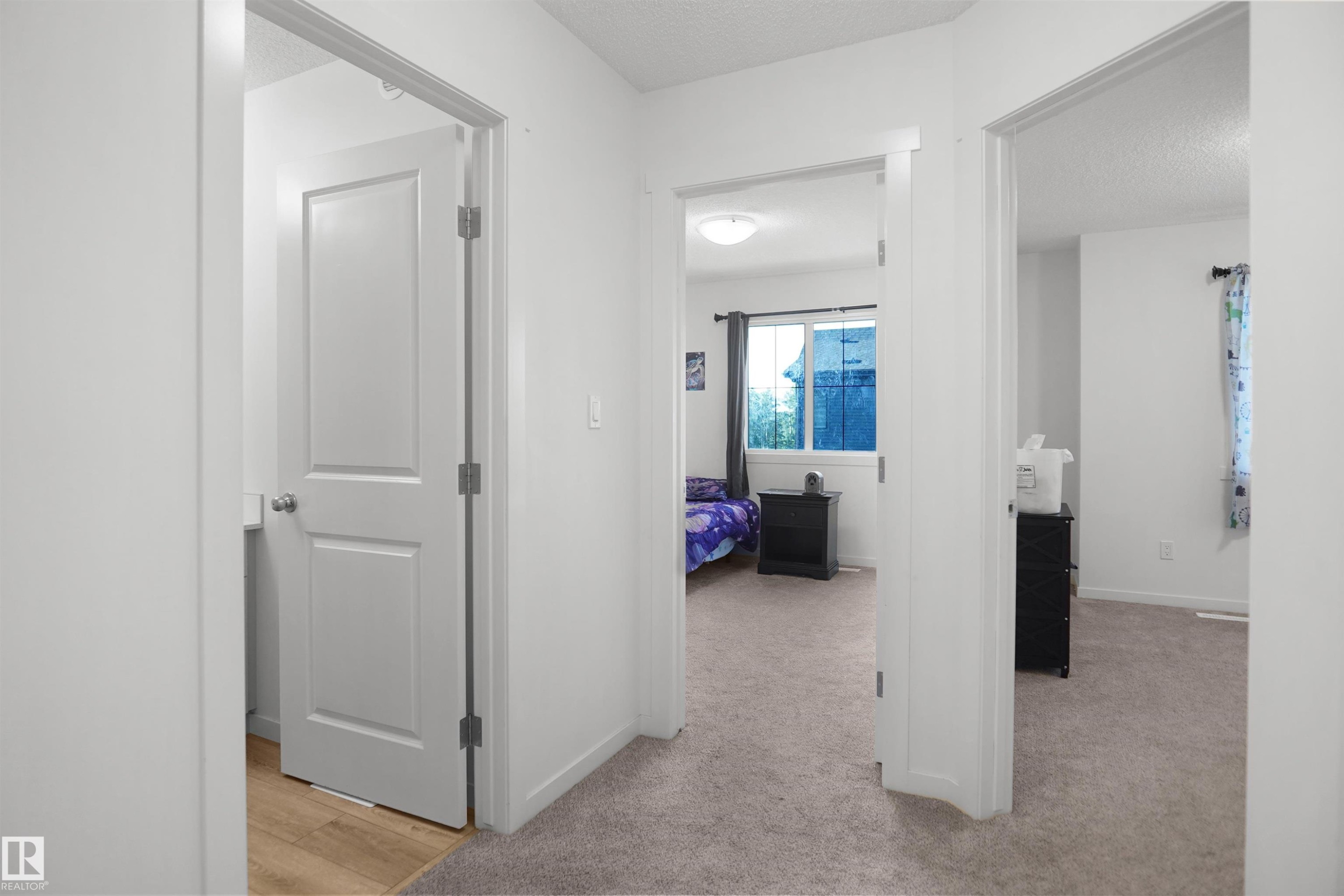 Interior hallway featuring light gray carpet, white walls, and white trim - #42 19904 31 Av Nw, Edmonton, AB - Indoor Photo Showing Other Room