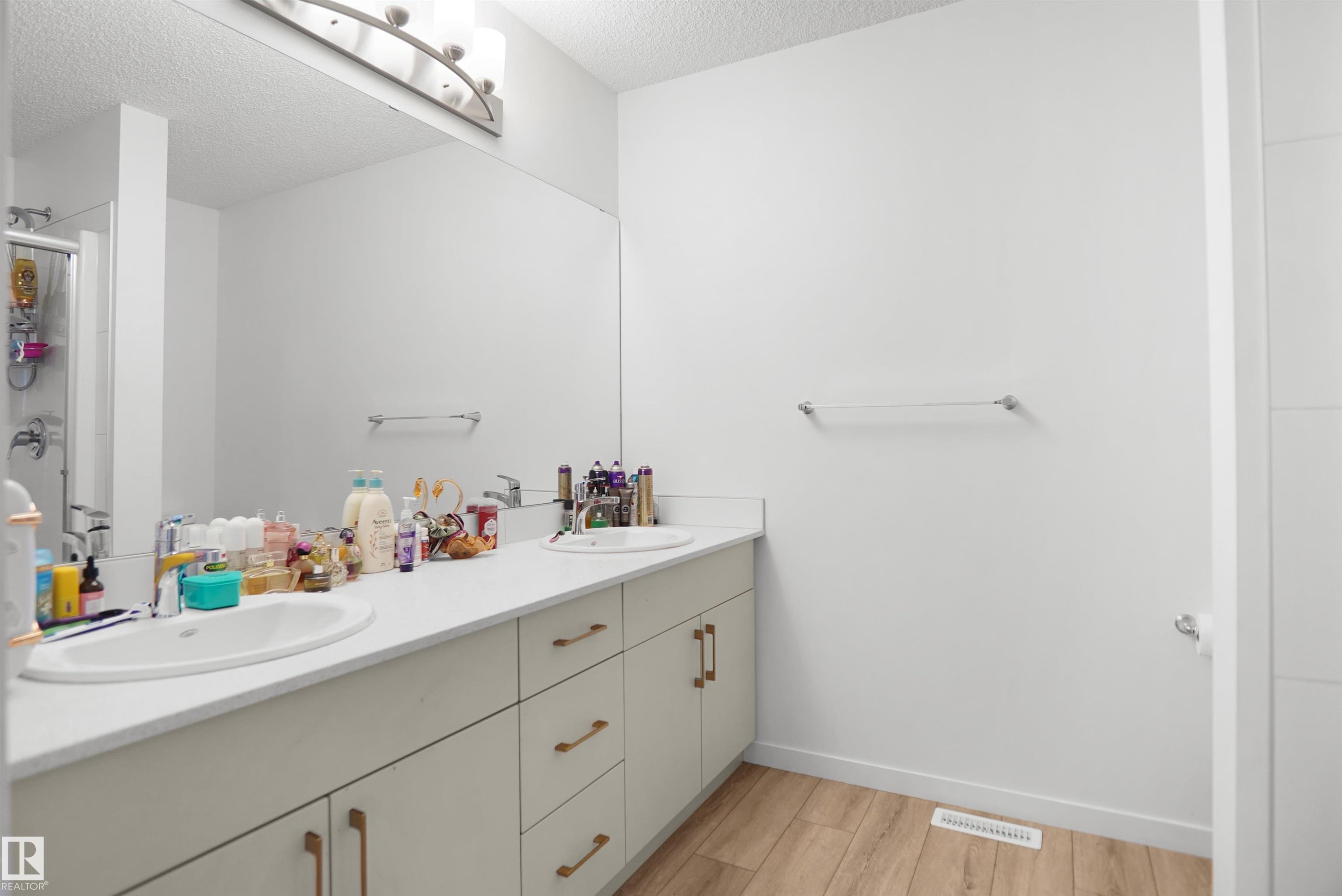 Double vanity with integrated sinks and white countertops - #42 19904 31 Av Nw, Edmonton, AB - Indoor Photo Showing Bathroom
