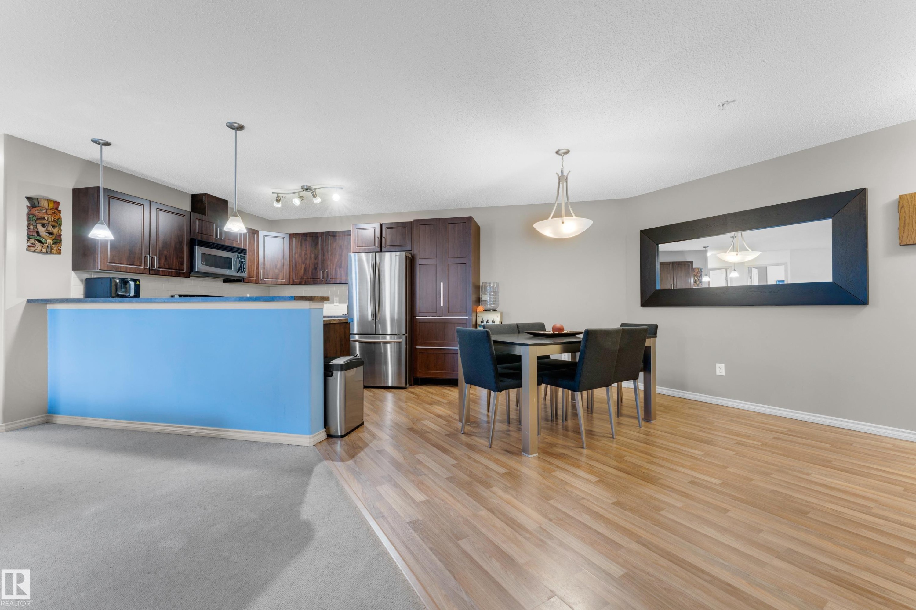 Open-concept kitchen and dining area with wood-finish flooring - #136 16035 132 St Nw, Edmonton, AB - Indoor