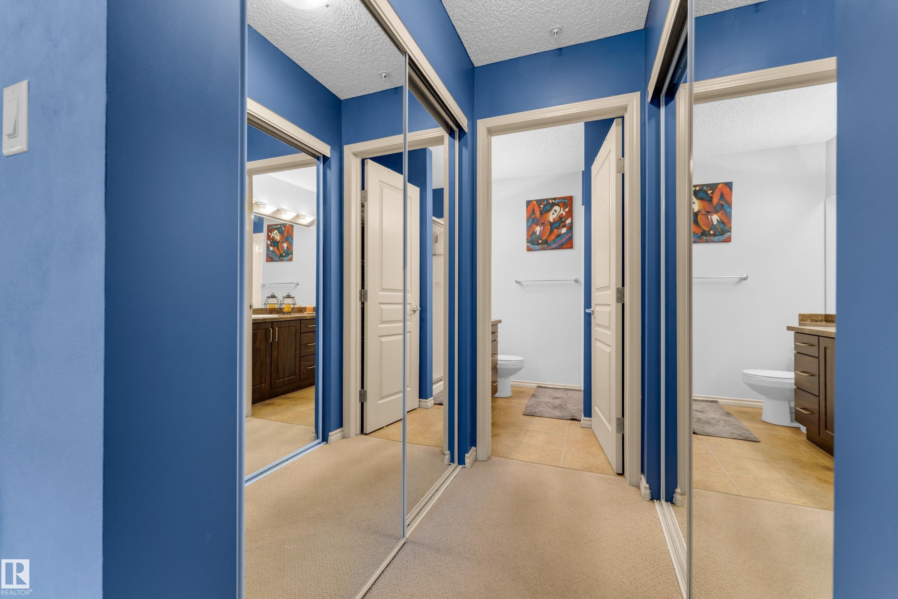 Mirrored closet doors offering a bright aesthetic - #136 16035 132 St Nw, Edmonton, AB - Indoor