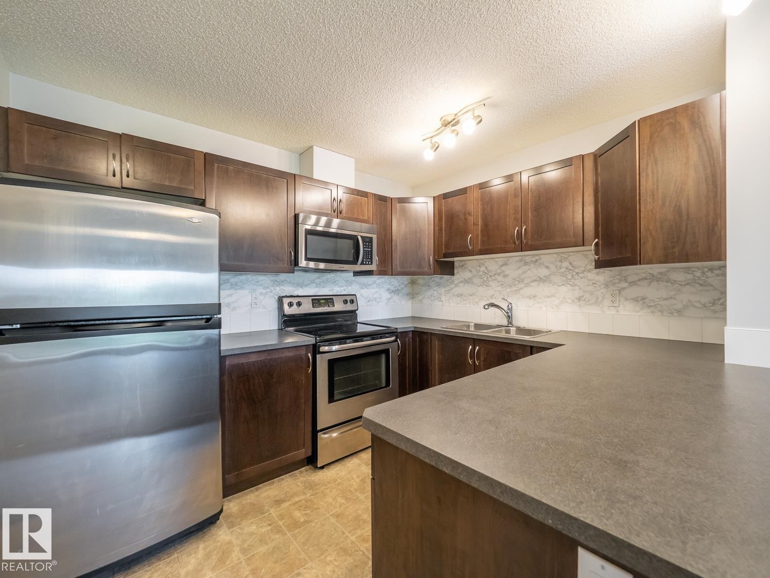#216 392 Silverberry Road Nw, Edmonton, AB - Indoor Photo Showing Kitchen With Stainless Steel Kitchen With Double Sink