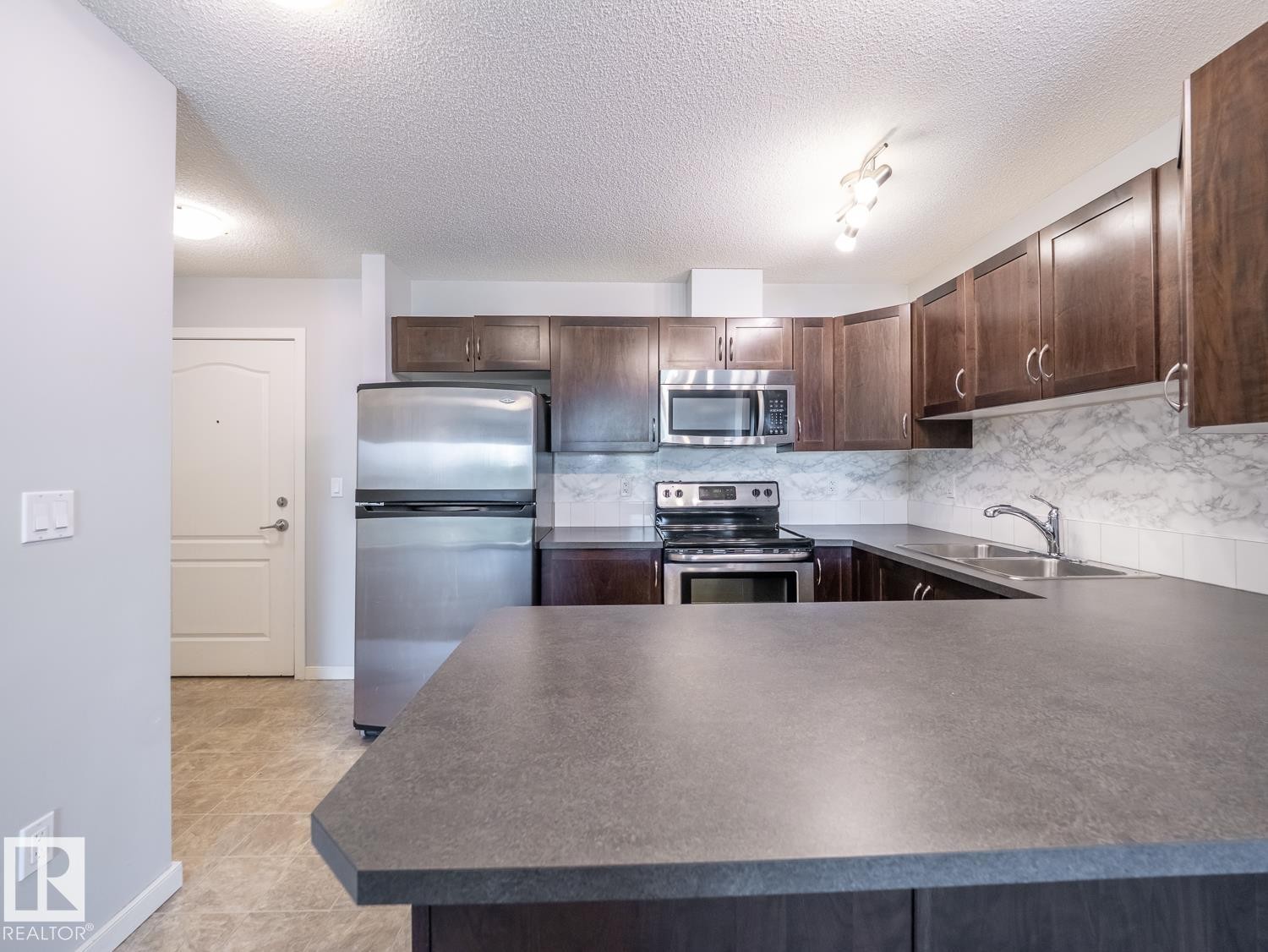 #216 392 Silverberry Road Nw, Edmonton, AB - Indoor Photo Showing Kitchen With Stainless Steel Kitchen With Double Sink