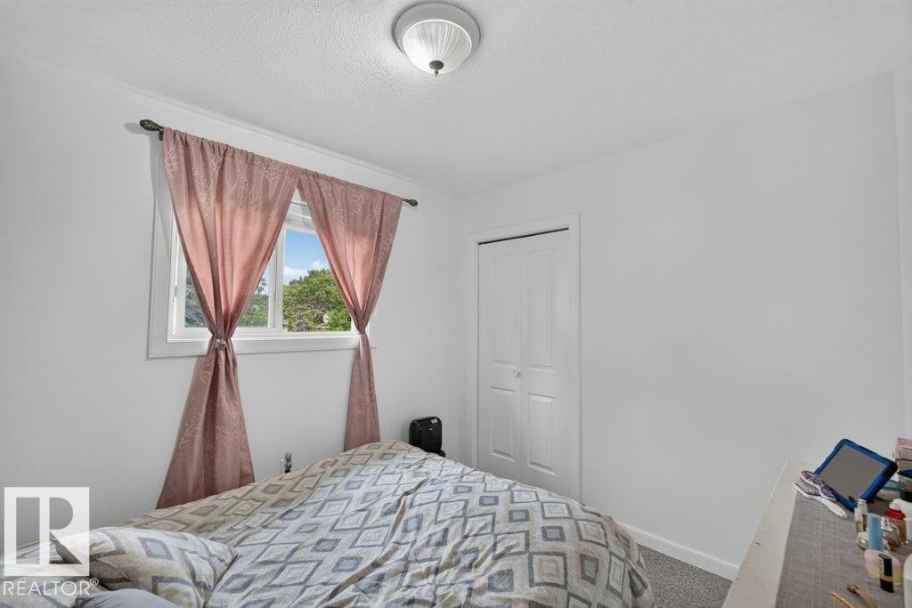 Room featuring light gray walls, white trim, and gray carpet - 12219 89 Street Nw, Edmonton, AB - Indoor Photo Showing Bedroom