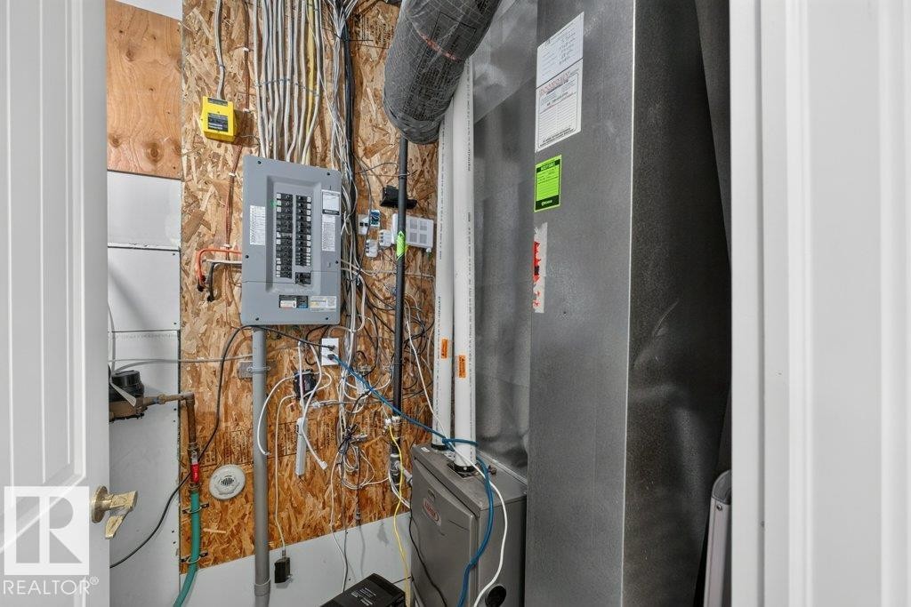 Electrical panel with visible circuit breakers - 12219 89 Street Nw, Edmonton, AB - Indoor Photo Showing Other Room
