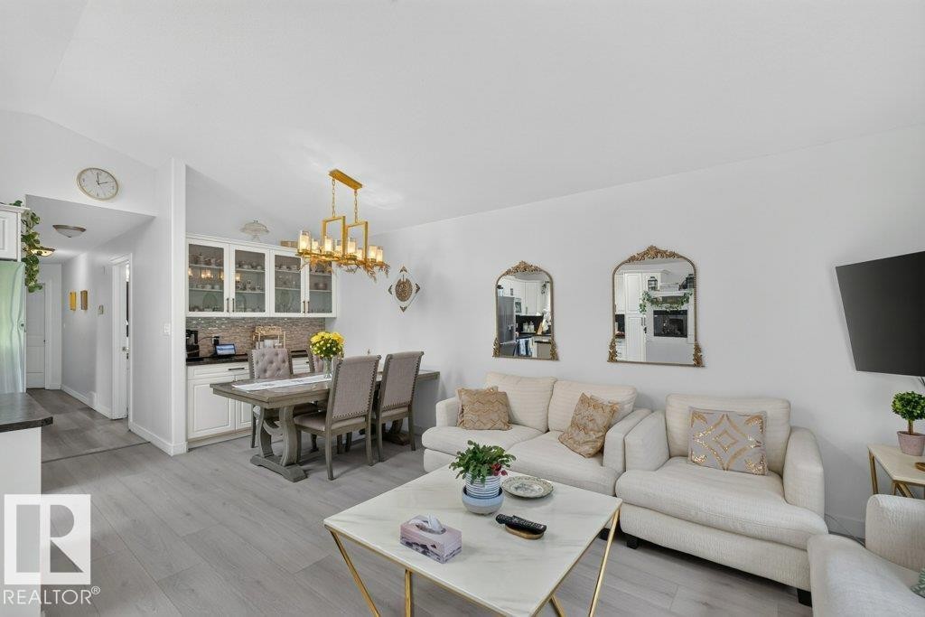 Open-concept living area with light wood-finish flooring, white walls, and recessed lighting - 12219 89 Street Nw, Edmonton, AB - Indoor Photo Showing Living Room