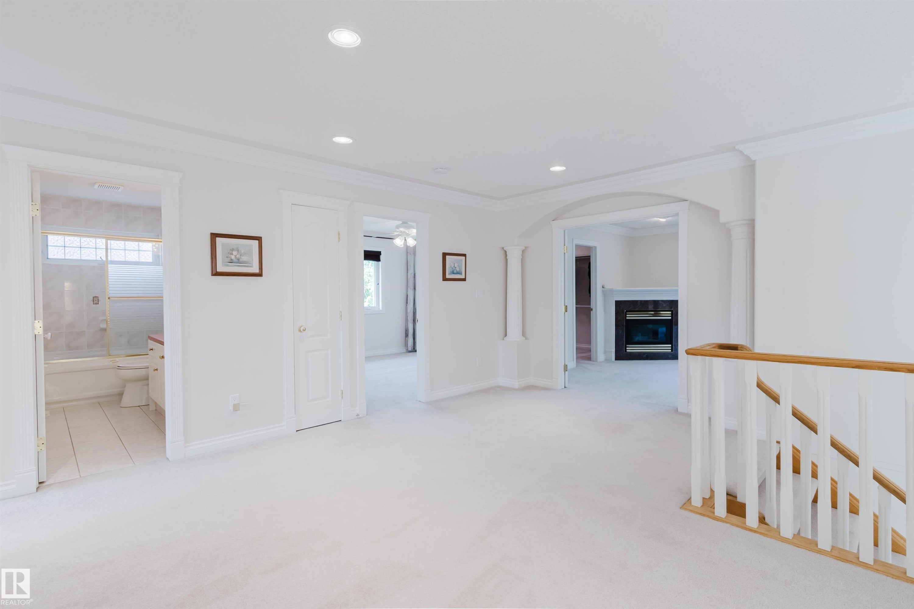 Carpeted interior area with recessed lighting and crown molding - 928 Heacock Road Nw, Edmonton, AB - Indoor Photo Showing Other Room With Fireplace