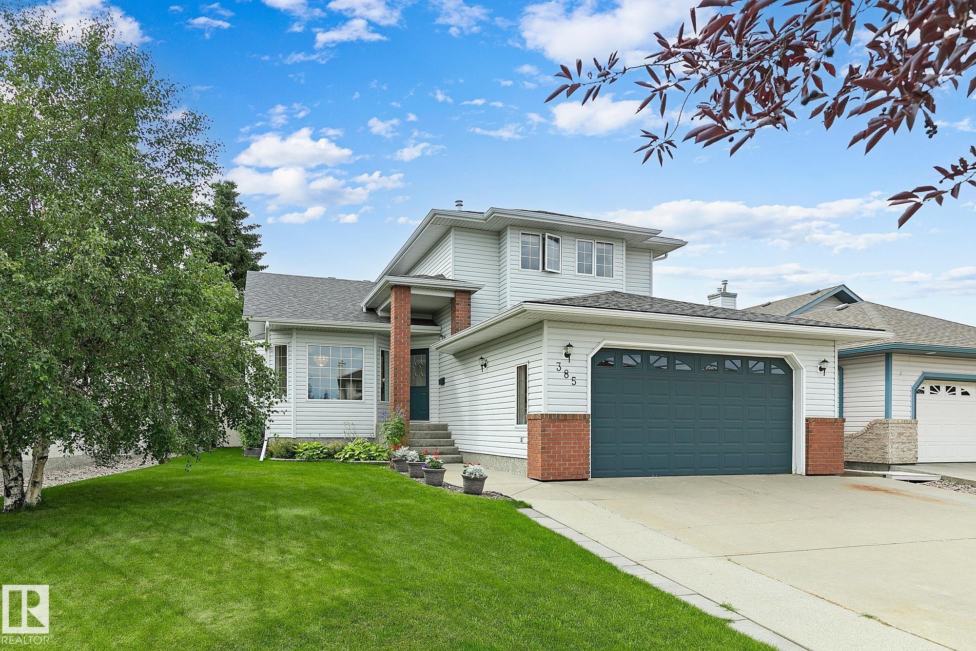 Two-story exterior with light-colored siding and brick accents - 385 Meadowview Terrace, Sherwood Park, AB - Outdoor With Facade
