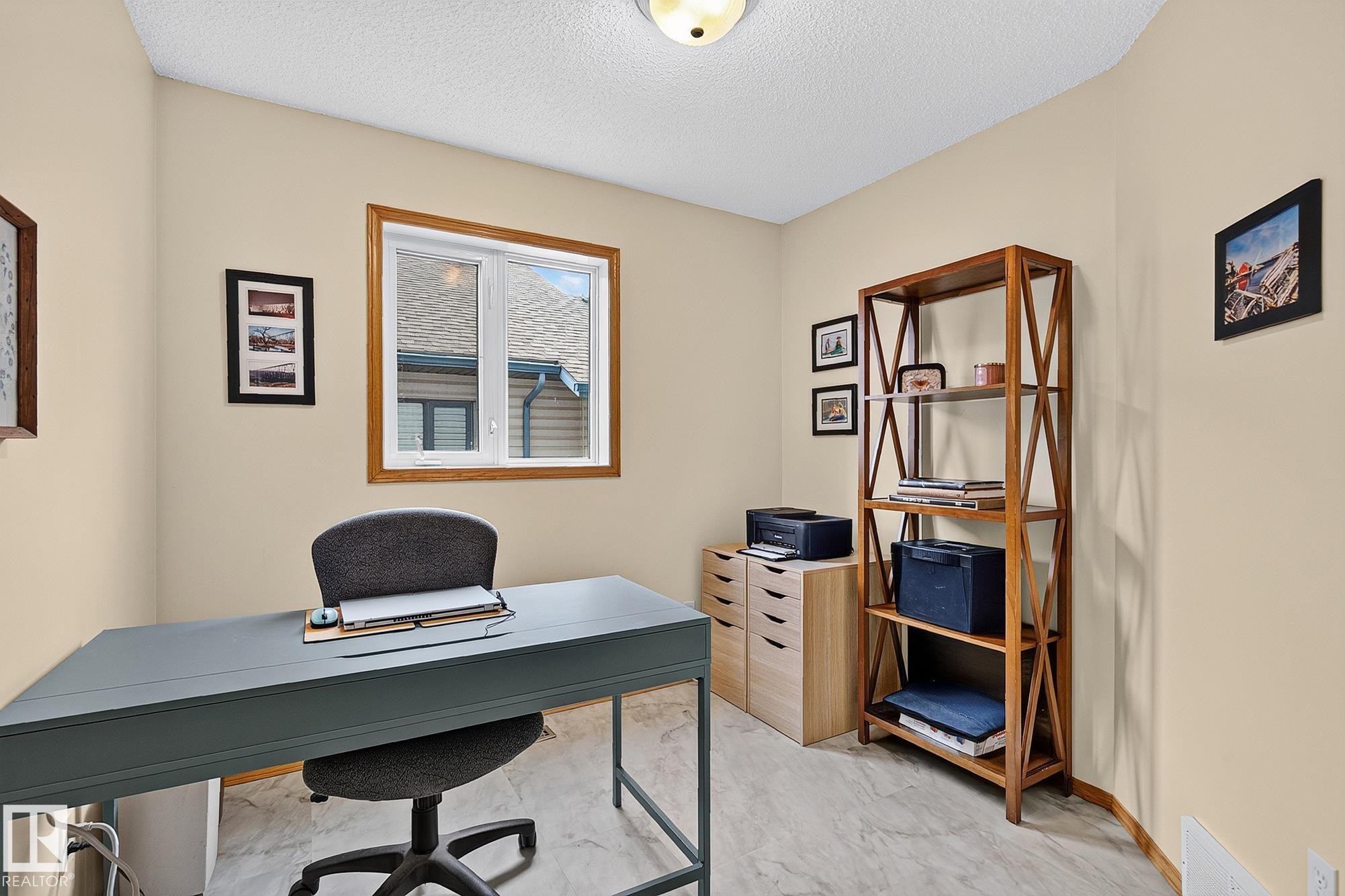 Versatile room used as a den featuring light-toned wall paint, a window with wood trim, and light-toned flooring - 385 Meadowview Terrace, Sherwood Park, AB - Indoor Photo Showing Office