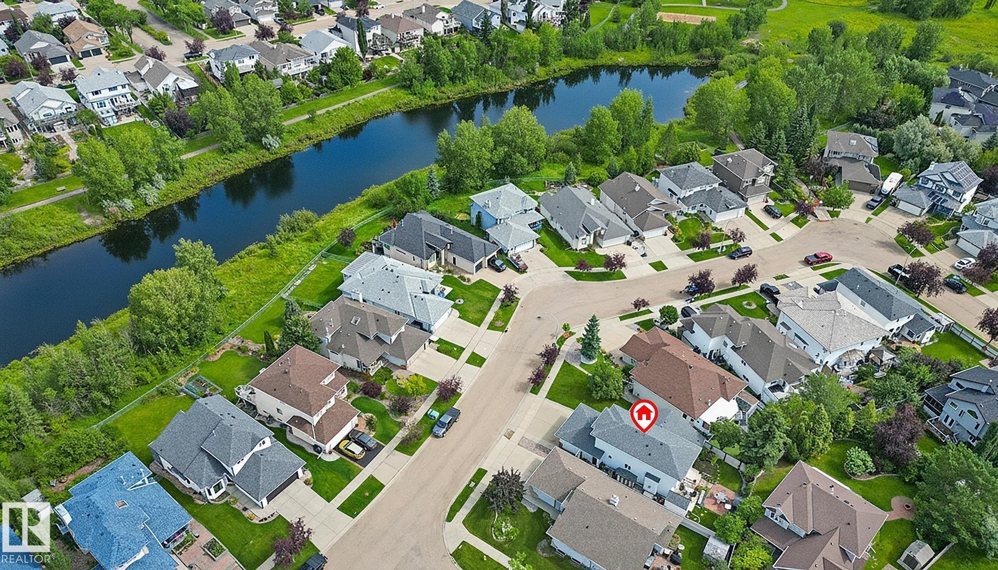 Aerial perspective showcasing the neighbourhood and Clarkdale Meadows Pond. - 385 Meadowview Terrace, Sherwood Park, AB - Outdoor With Body Of Water With View