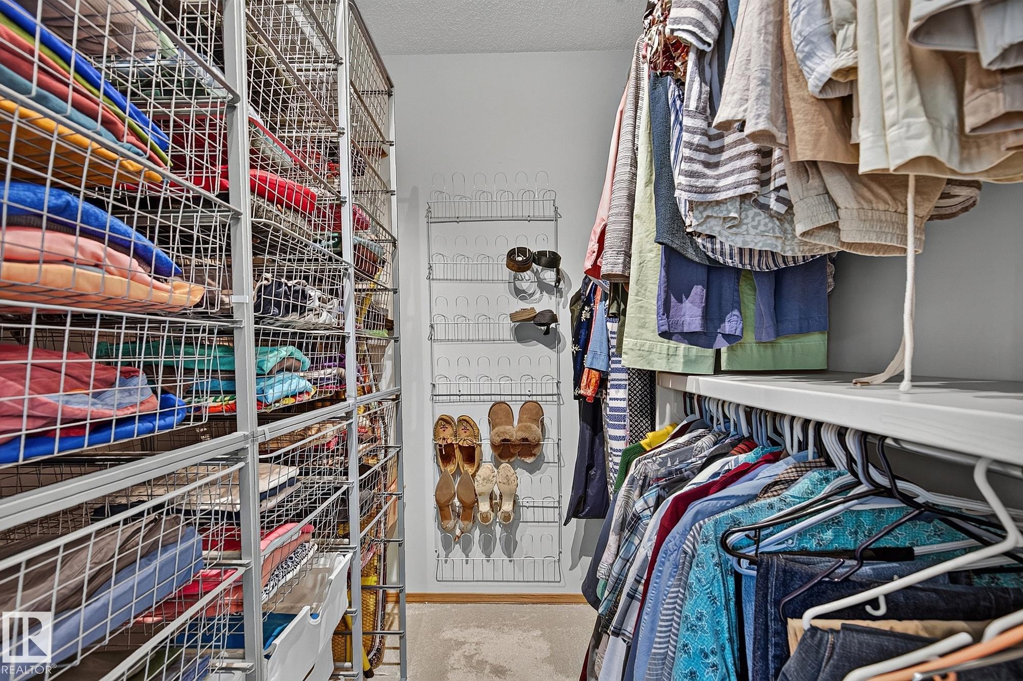 Walk-in closet in the primary bedroom featuring extensive wire shelving storage, a multi-tiered shoe rack, and integrated clothing rods - 385 Meadowview Terrace, Sherwood Park, AB - Indoor With Storage