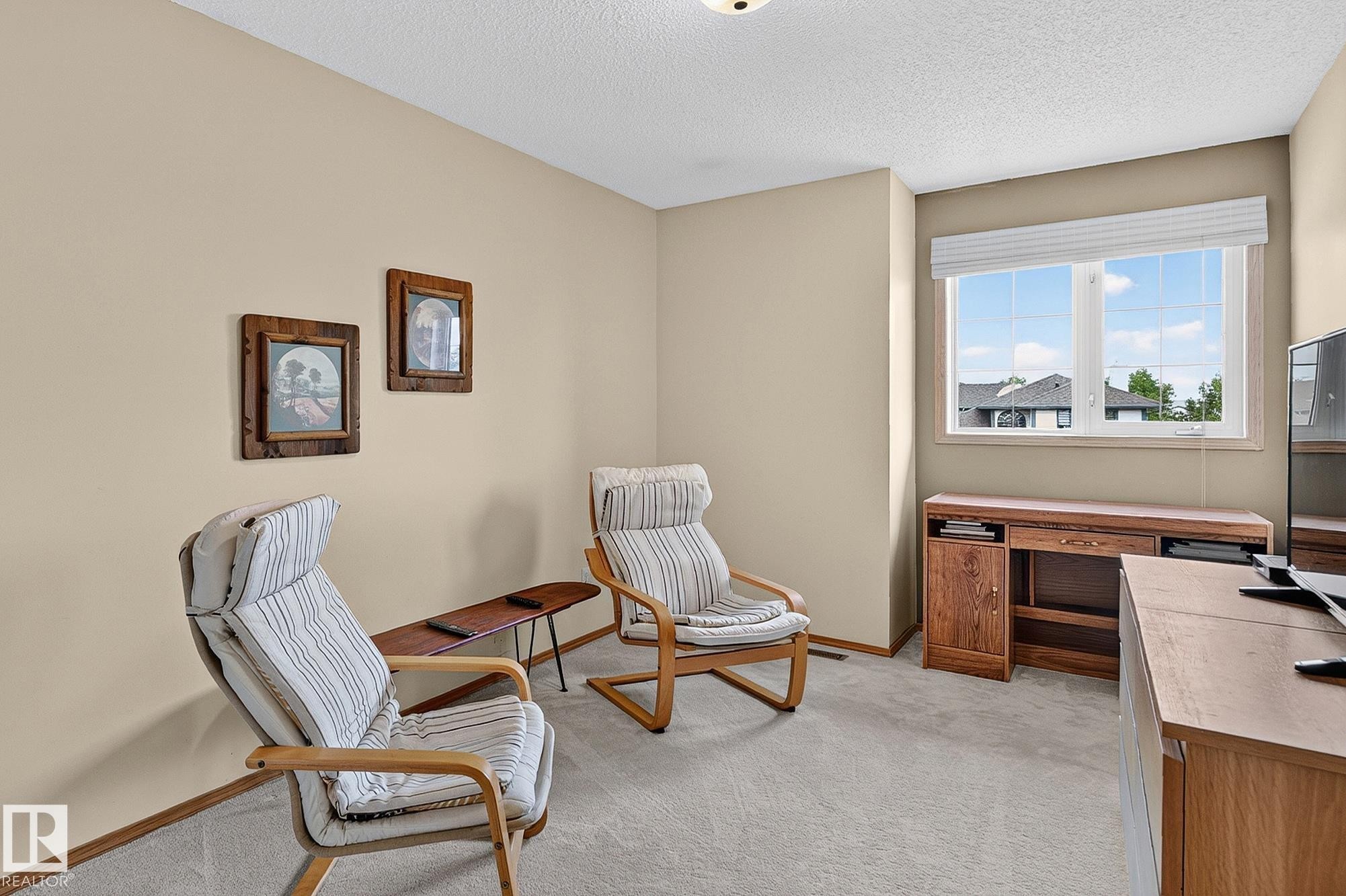 Bedroom 3 is a carpeted room with a large window and neutral-toned walls - 385 Meadowview Terrace, Sherwood Park, AB - Indoor Photo Showing Other Room